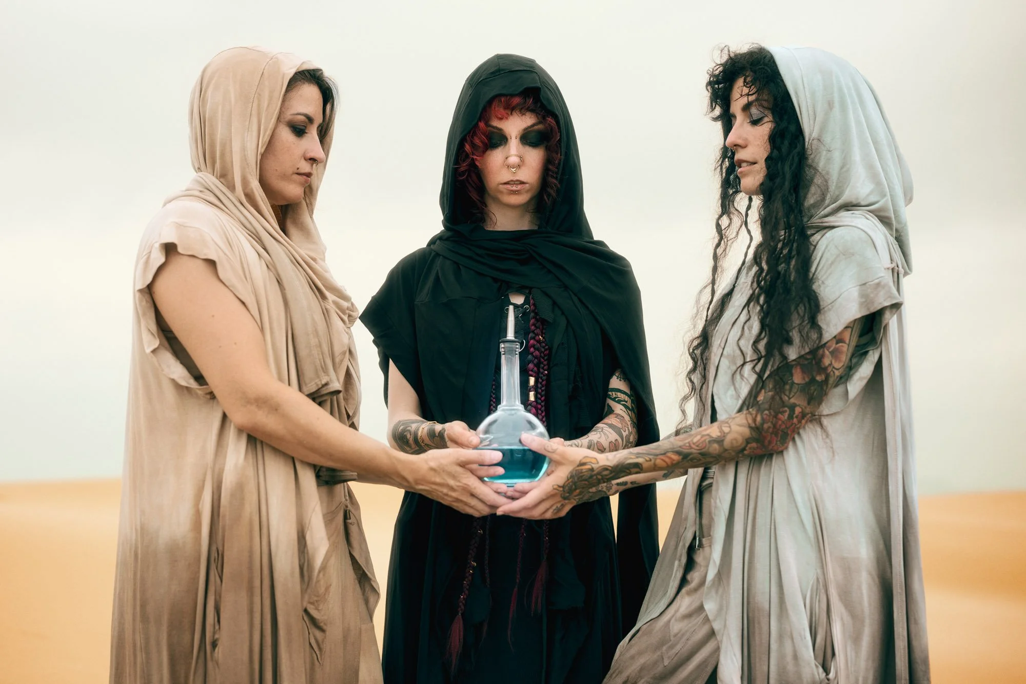Reverend Mother and two Fremen performing a ritual with the Water of Life