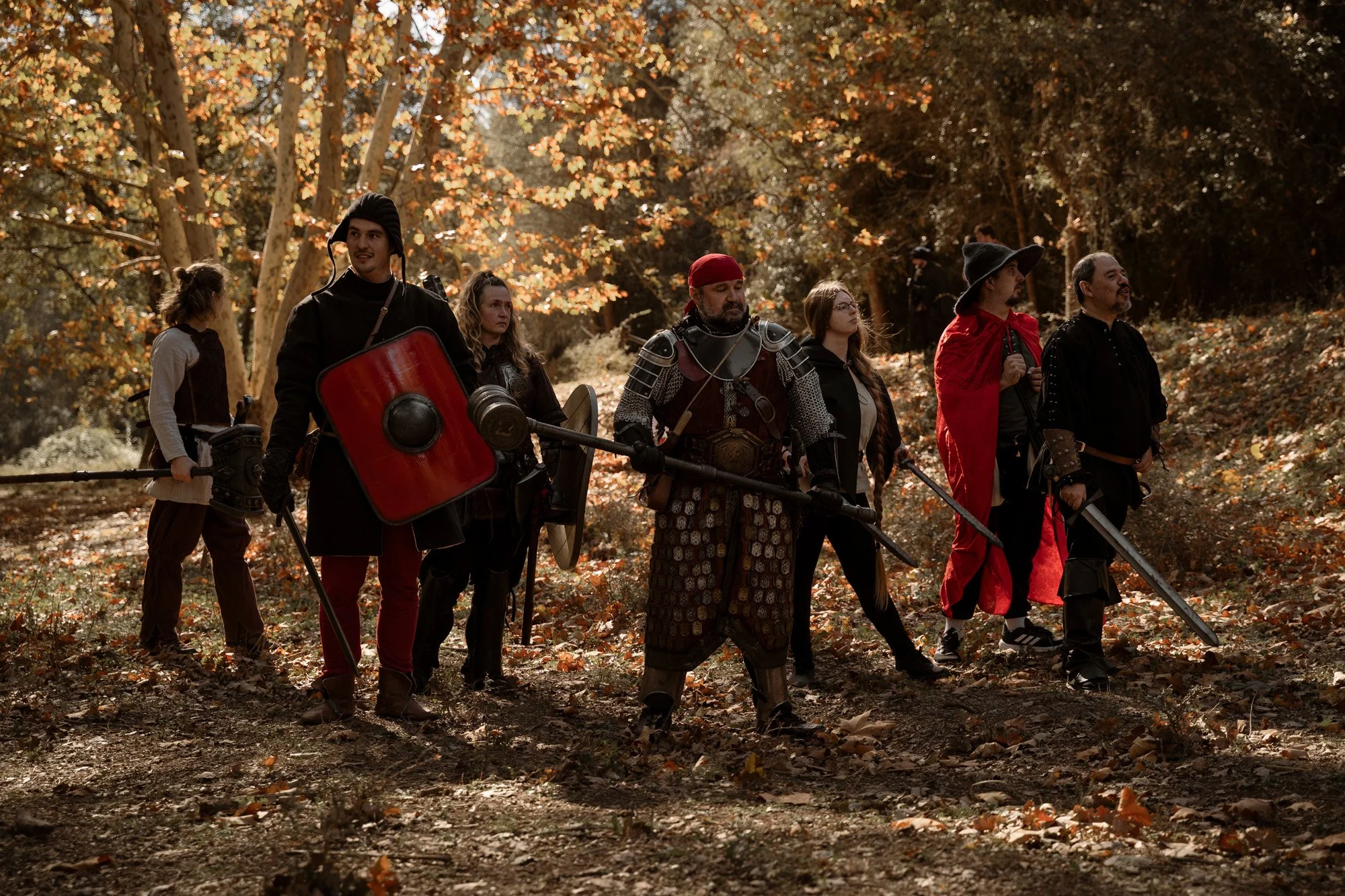 Group of LARP participants in medieval costumes preparing for a scene during a live action role play event.