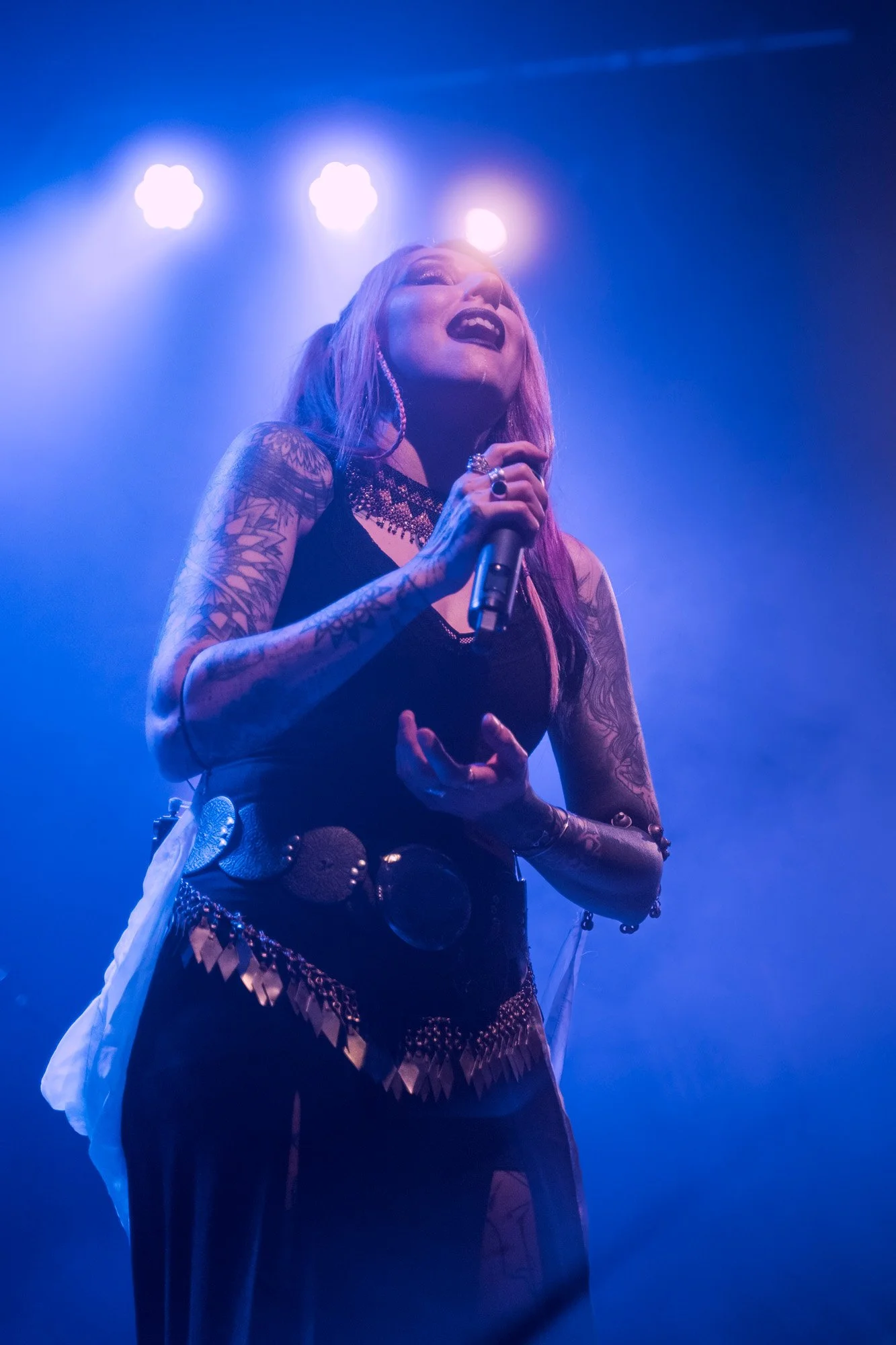 Close-up of Kris Vega performing vocals, emotional moment during live concert.