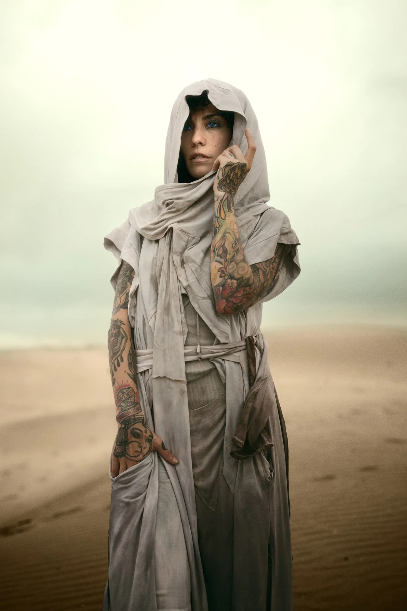 Sandra Roll standing in the desert wearing layered flowing clothing in a Dune-inspired portrait