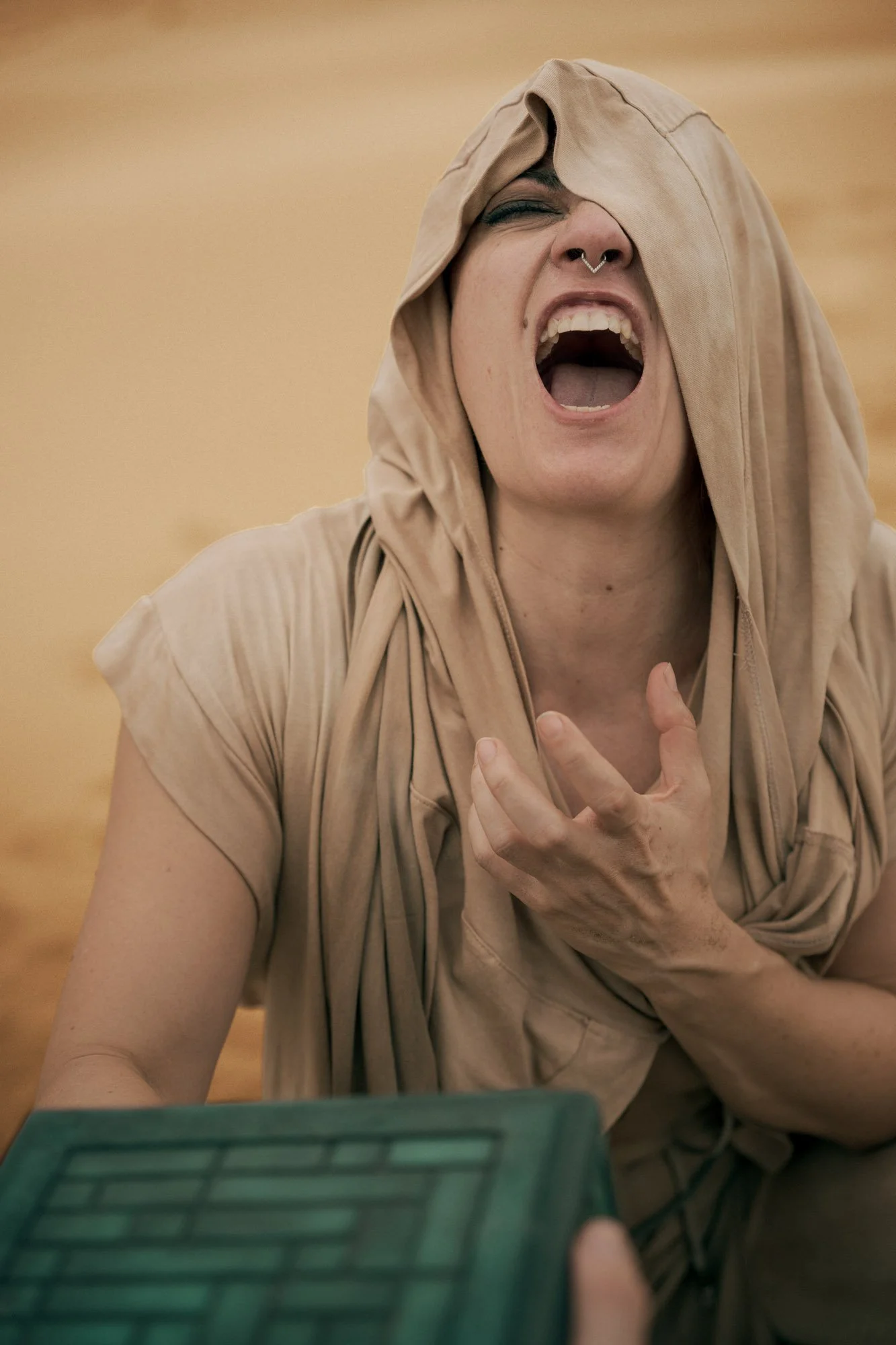 Lidia Martin reacting to the Gom Jabbar test in a Dune-inspired desert scene