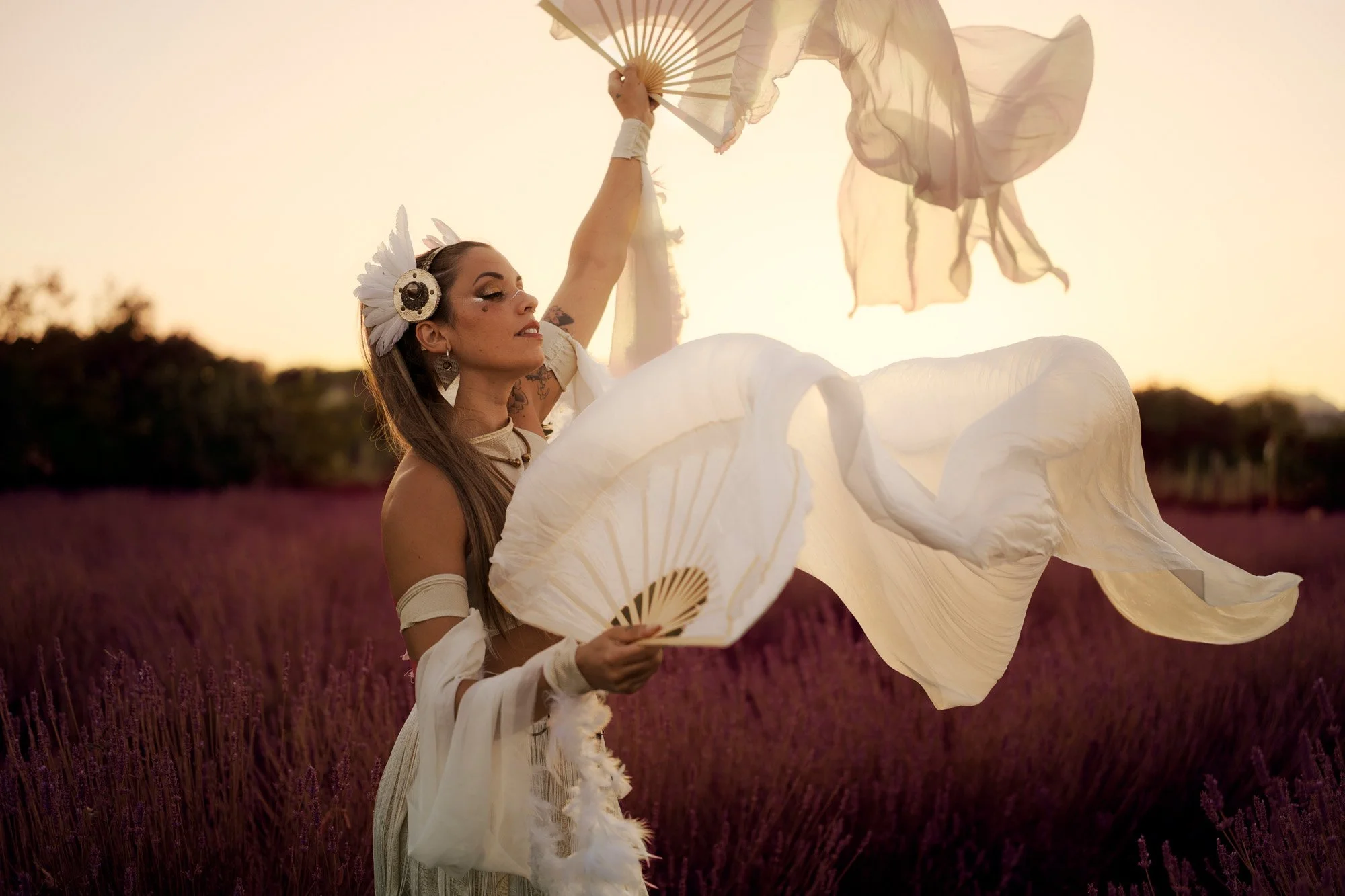 Dynamic tribal fusion dance portrait with flowing fabric captured at golden hour.