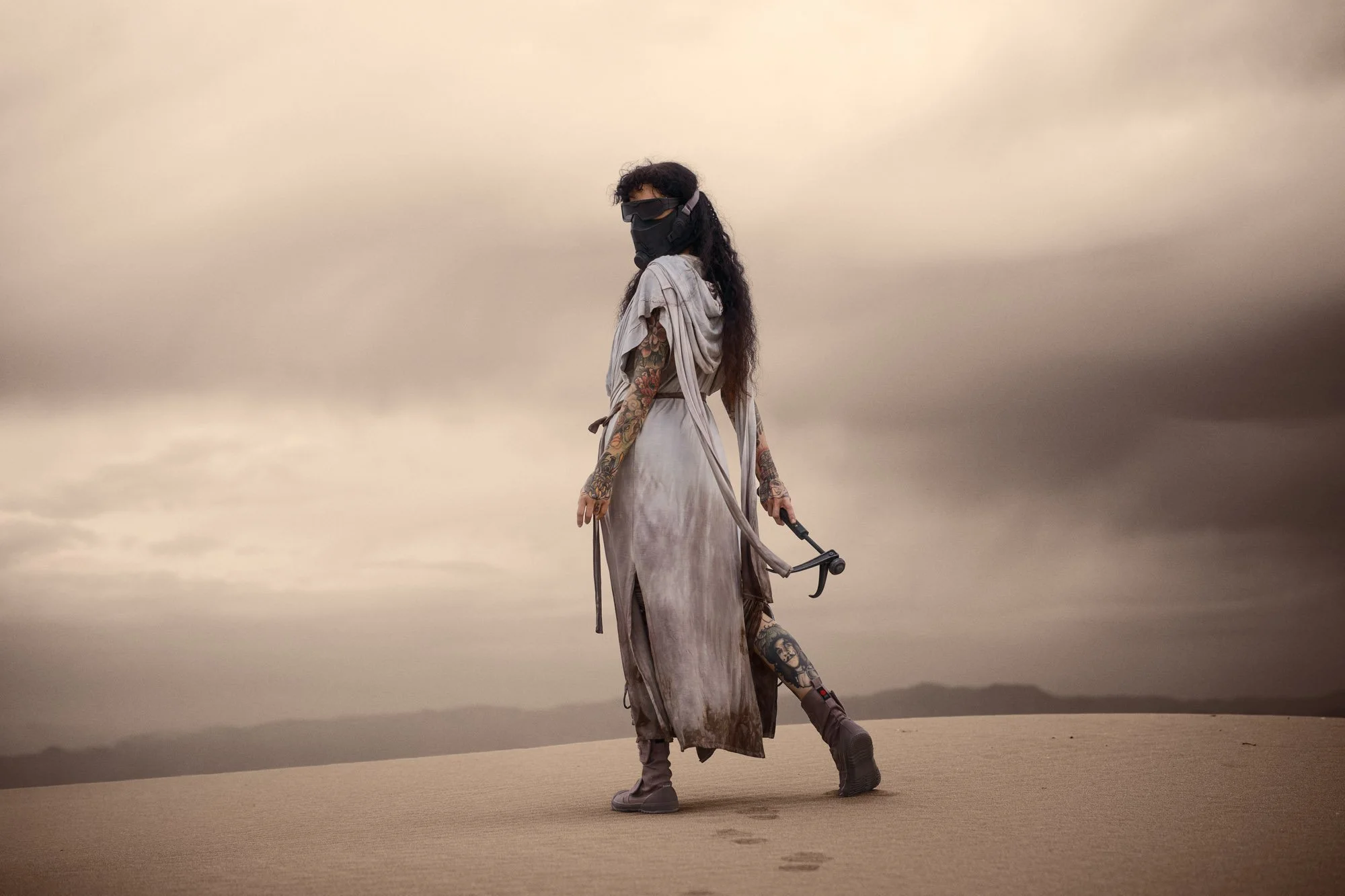 Sandra Roll waiting shau-hulud in Fremen-inspired costume beneath a darkening sky