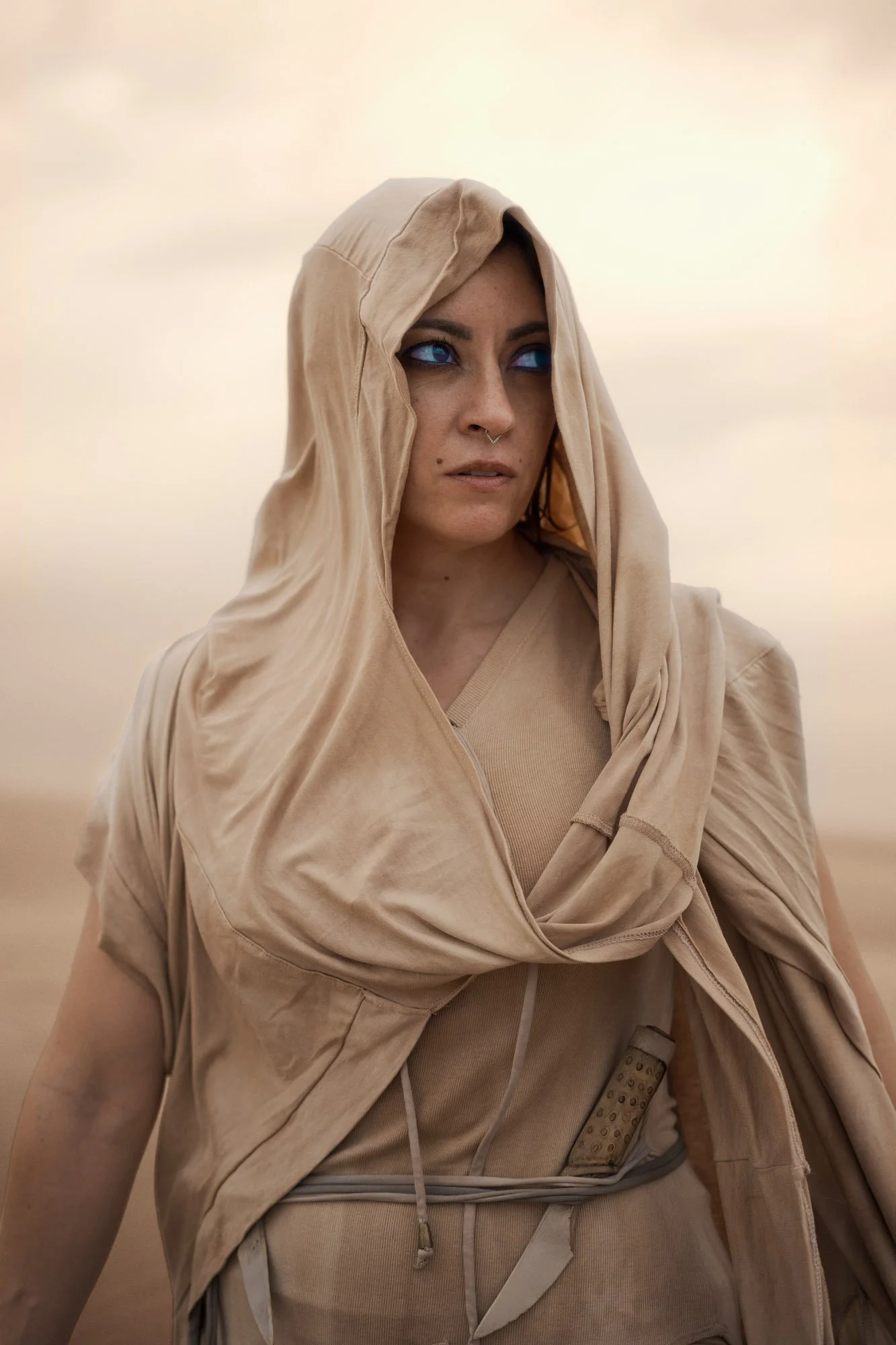 Lidia Martin as a Fremen wanderer standing in the desert of Arrakis