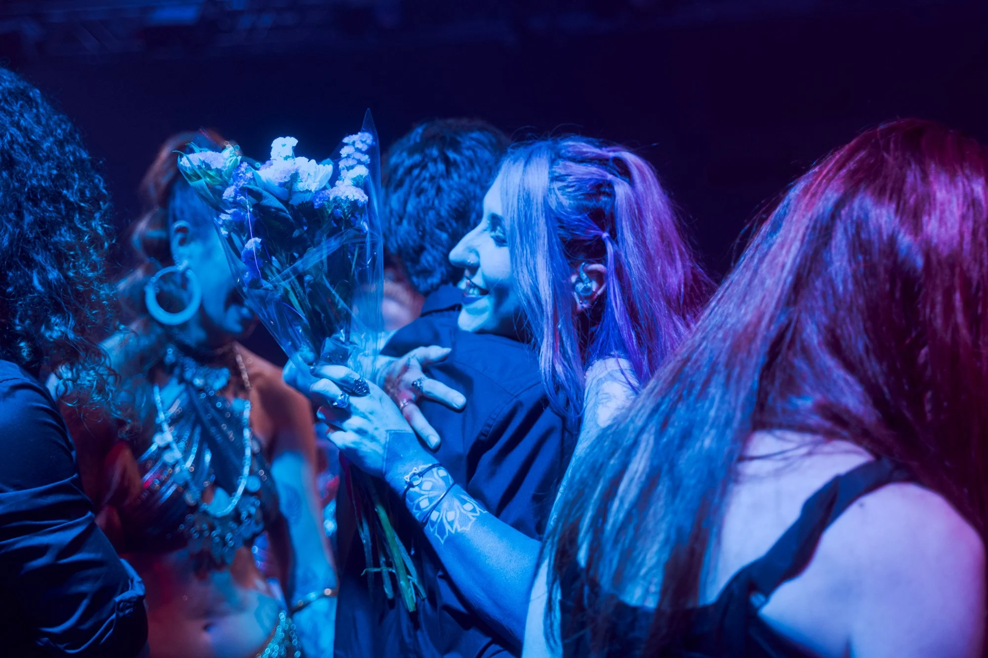 Emotional moment of musicians hugging each other at the end of the Serapis Project live performance.