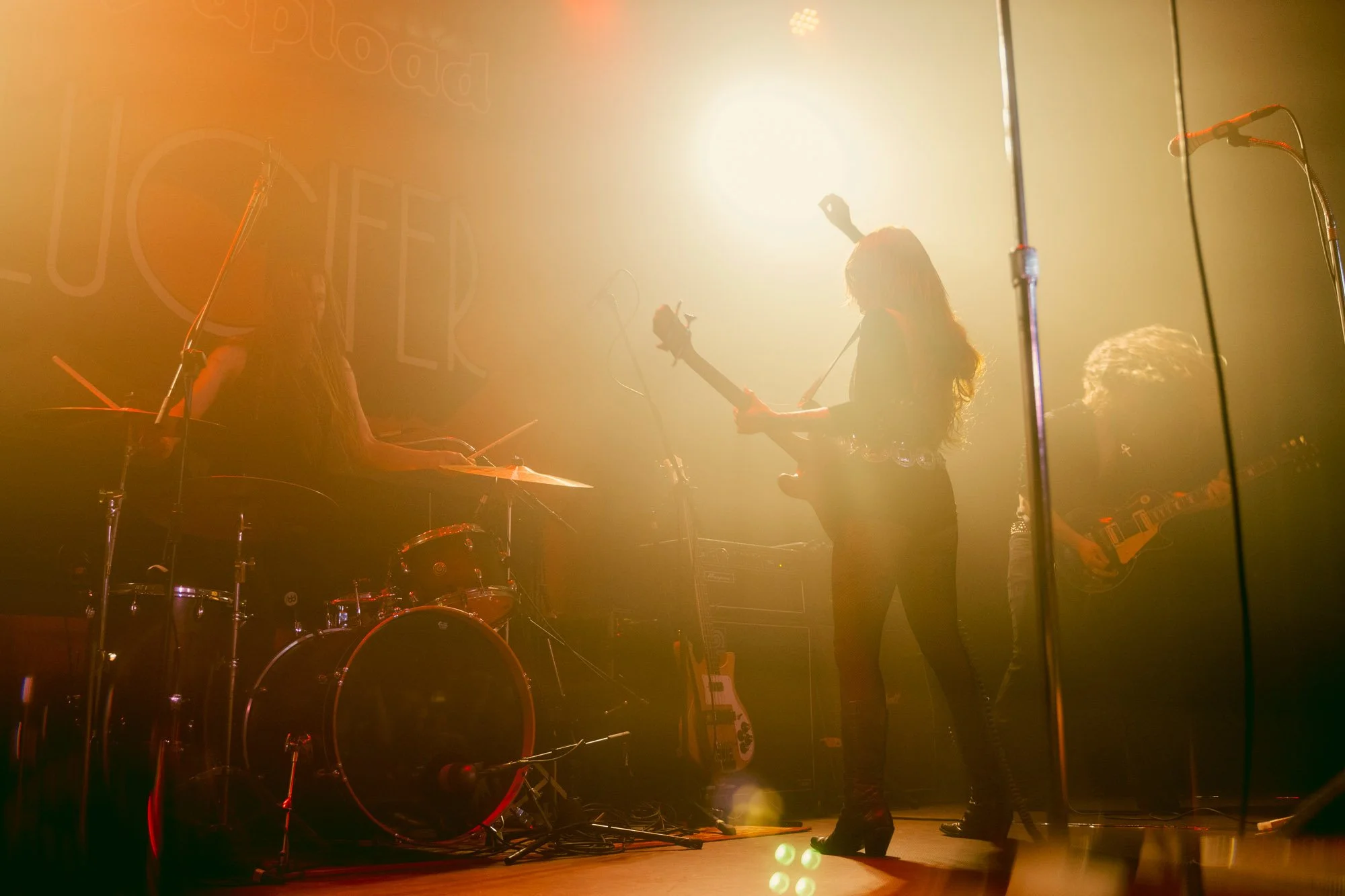 band performing in silhouette under warm stage lighting