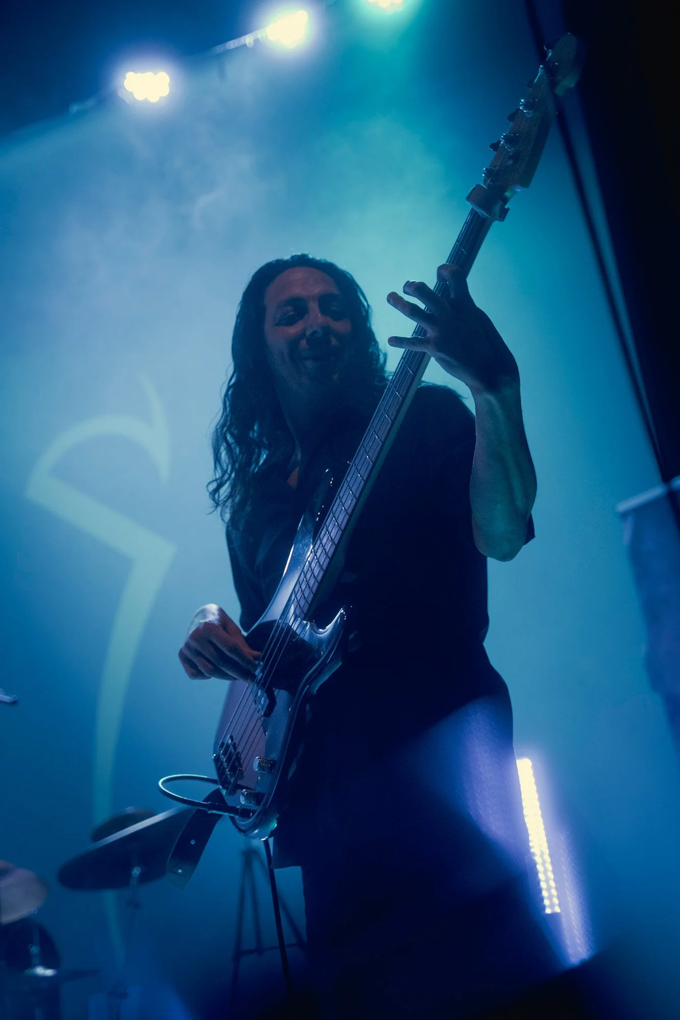 Bassist performing live on stage during Serapis Project concert.