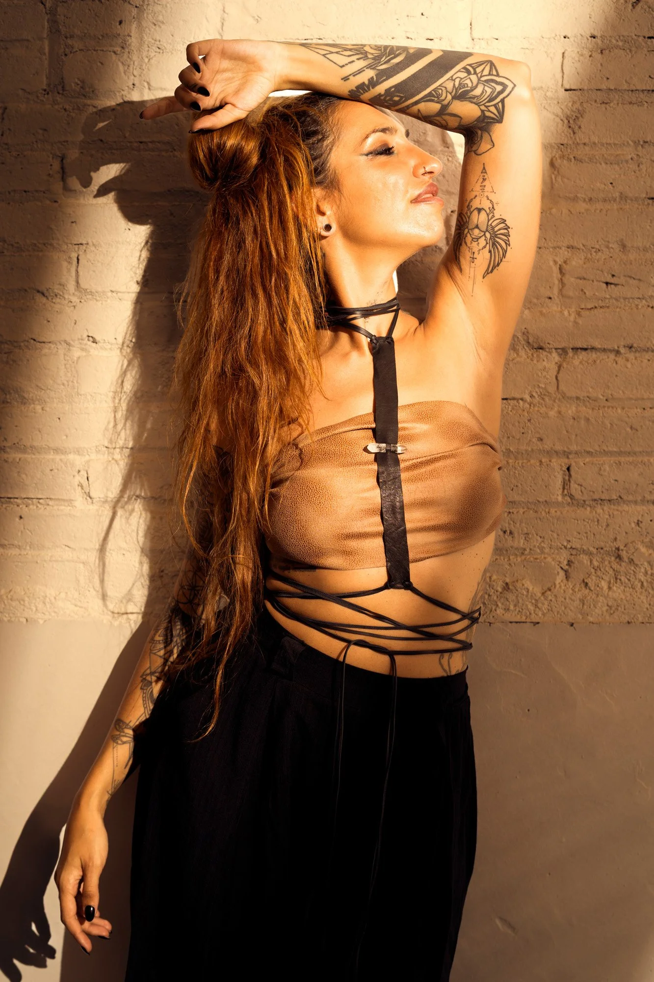 Studio fashion portrait exploring body movement, industrial boho styling and dramatic flash lighting.