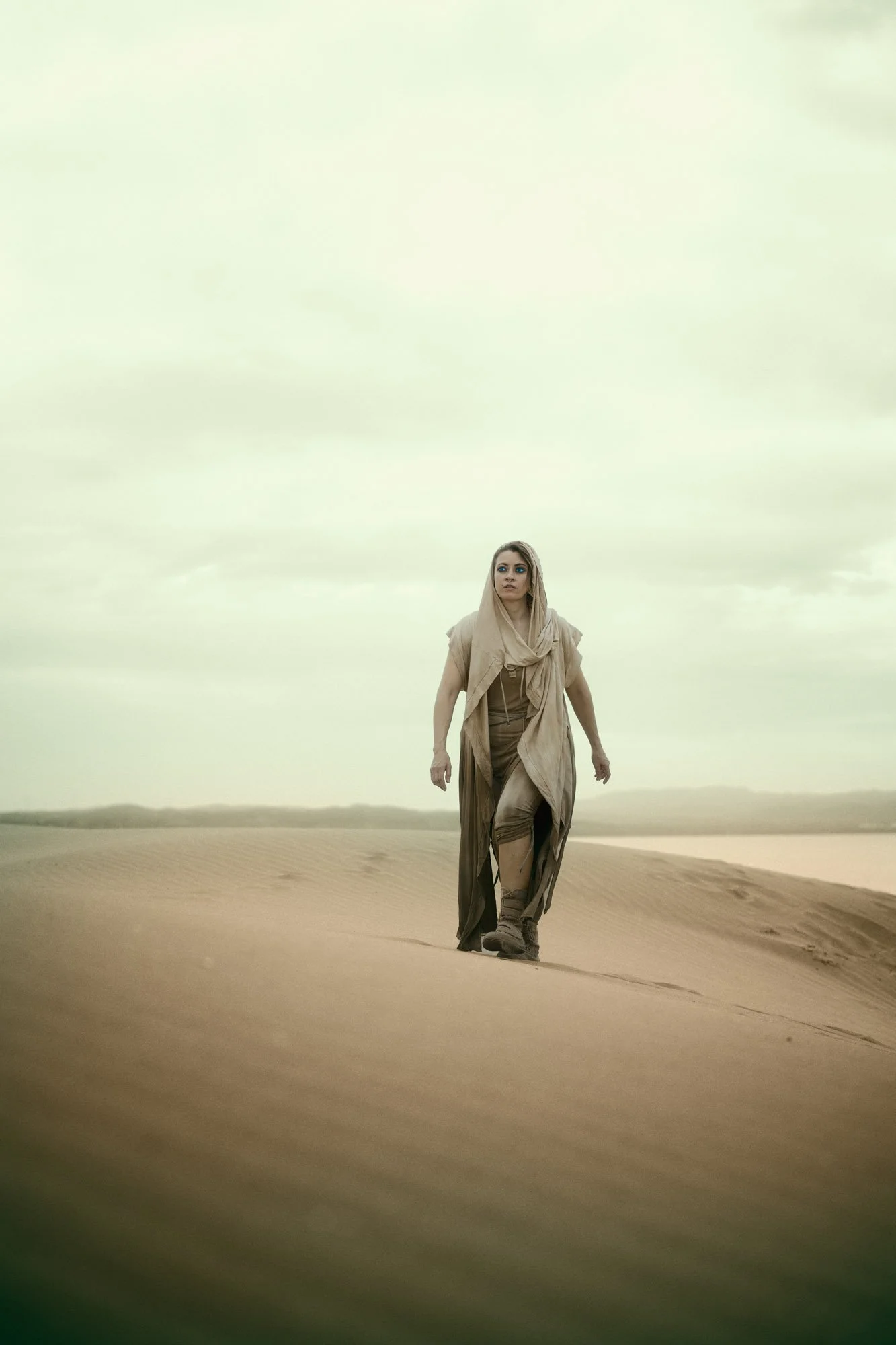 Lidia Martin walking through the desert in flowing clothing in a Dune-inspired portrait
