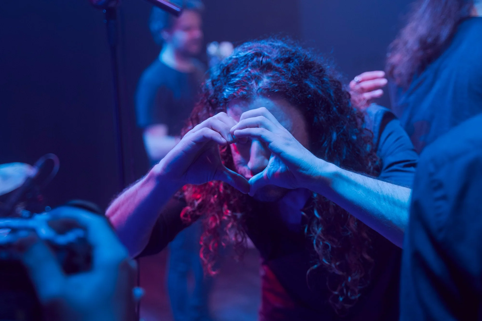 Guest guitarist making a heart symbol toward the videographer during Serapis Project live concert.