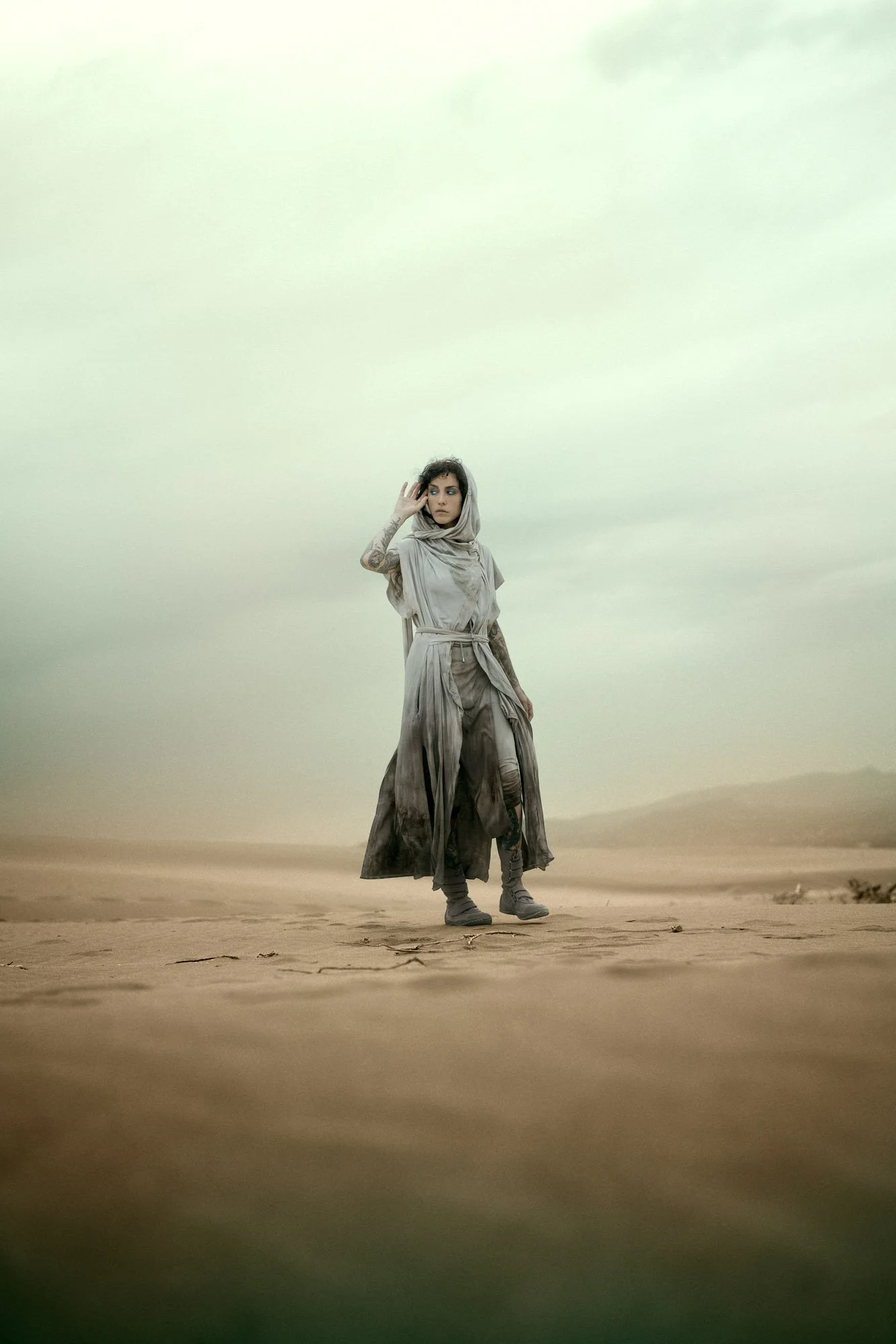 Sandra Roll standing in the desert wearing flowing costume in a Dune-inspired portrait