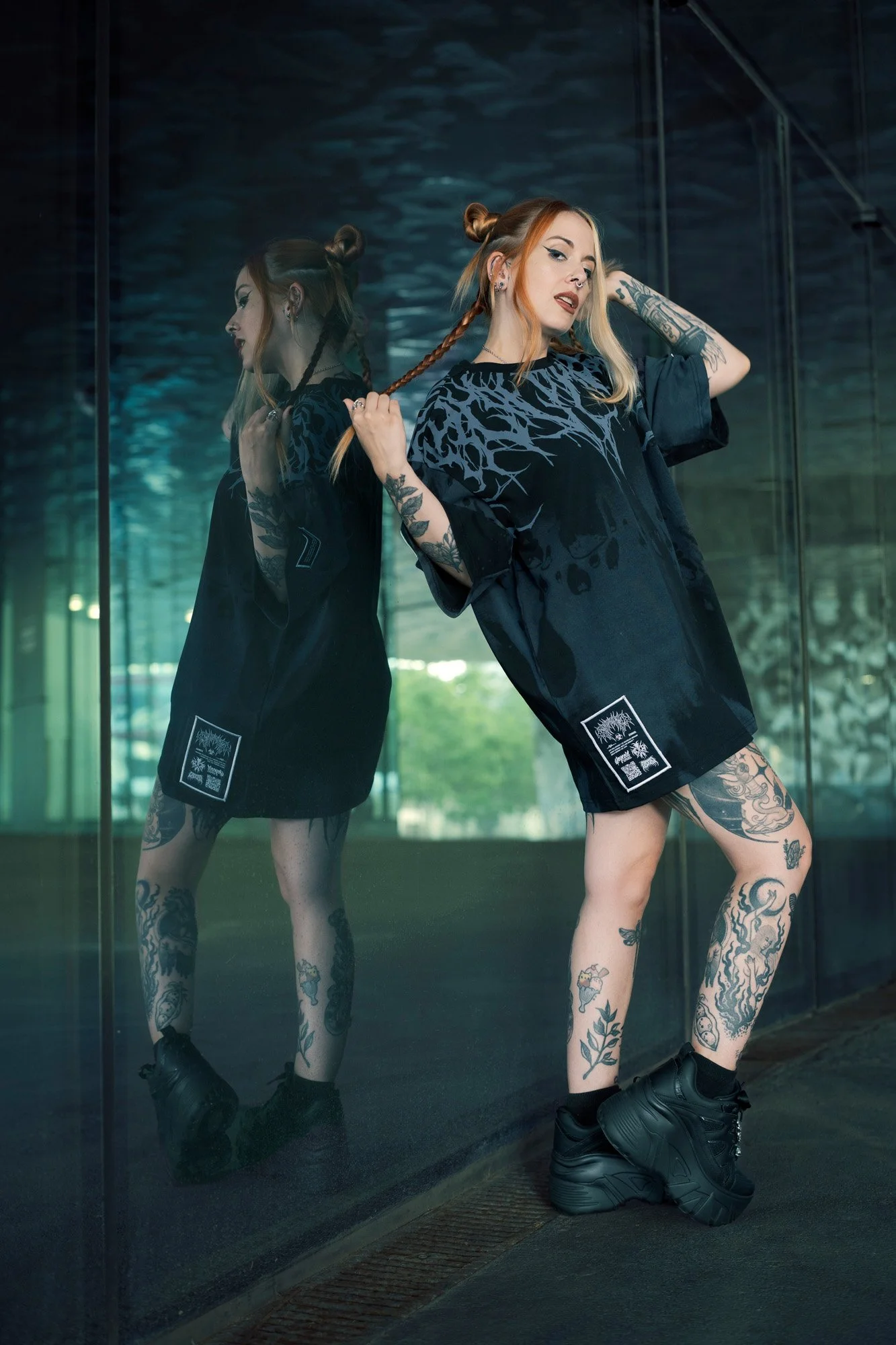 Full body urban fashion portrait with concrete and glass textures