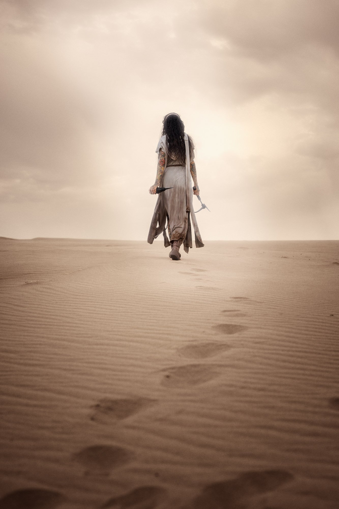 Sandra Roll walking alone across the desert as a Fremen wanderer