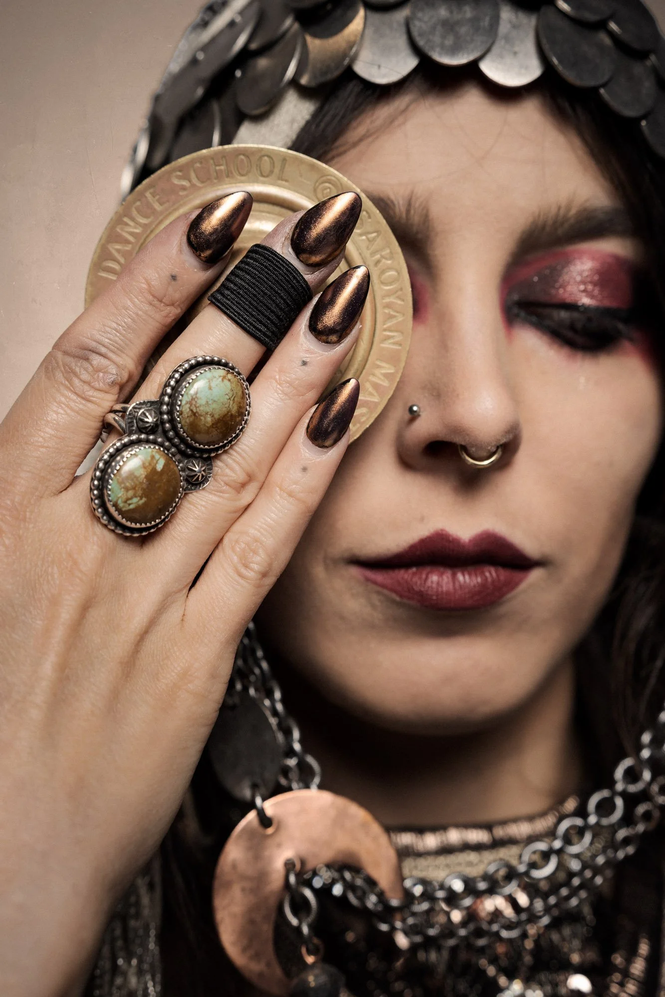 close-up portrait detail with jewelry and hand covering one eye
