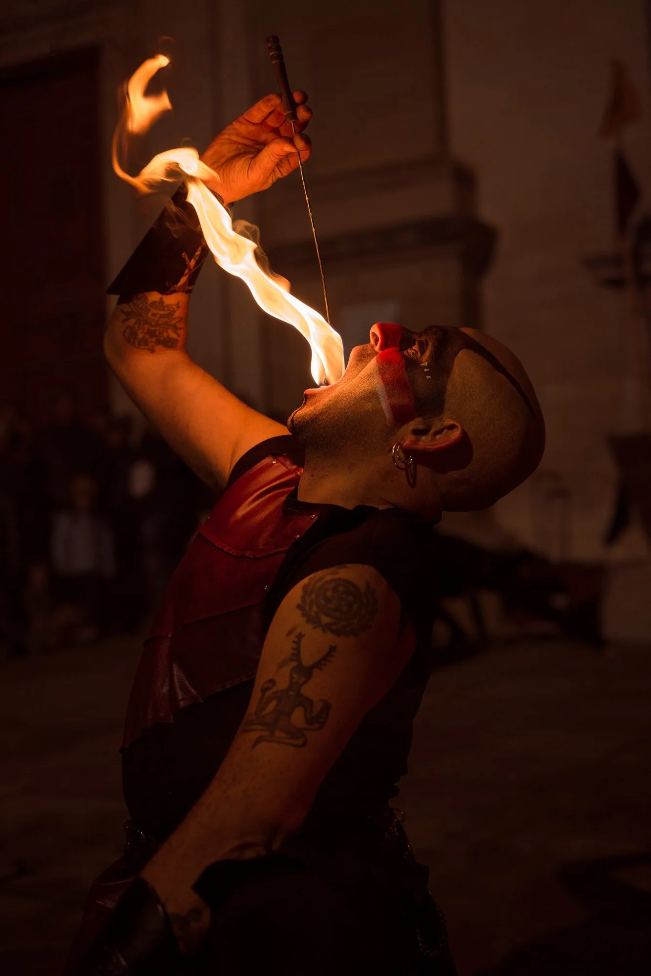 Fire eater by La Nariz Roja performing during a night street event, mercat medieval Vic, Spain.