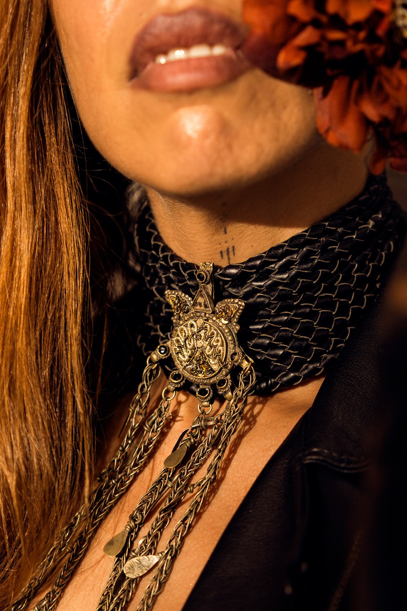 Close-up portrait of boho industrial necklace and textures under hard studio flash lighting