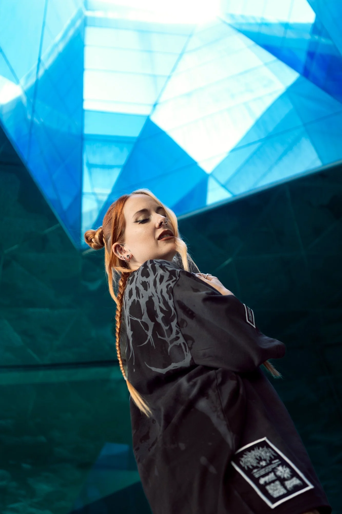Low-angle portrait of Shara Wolf against modern architectural background