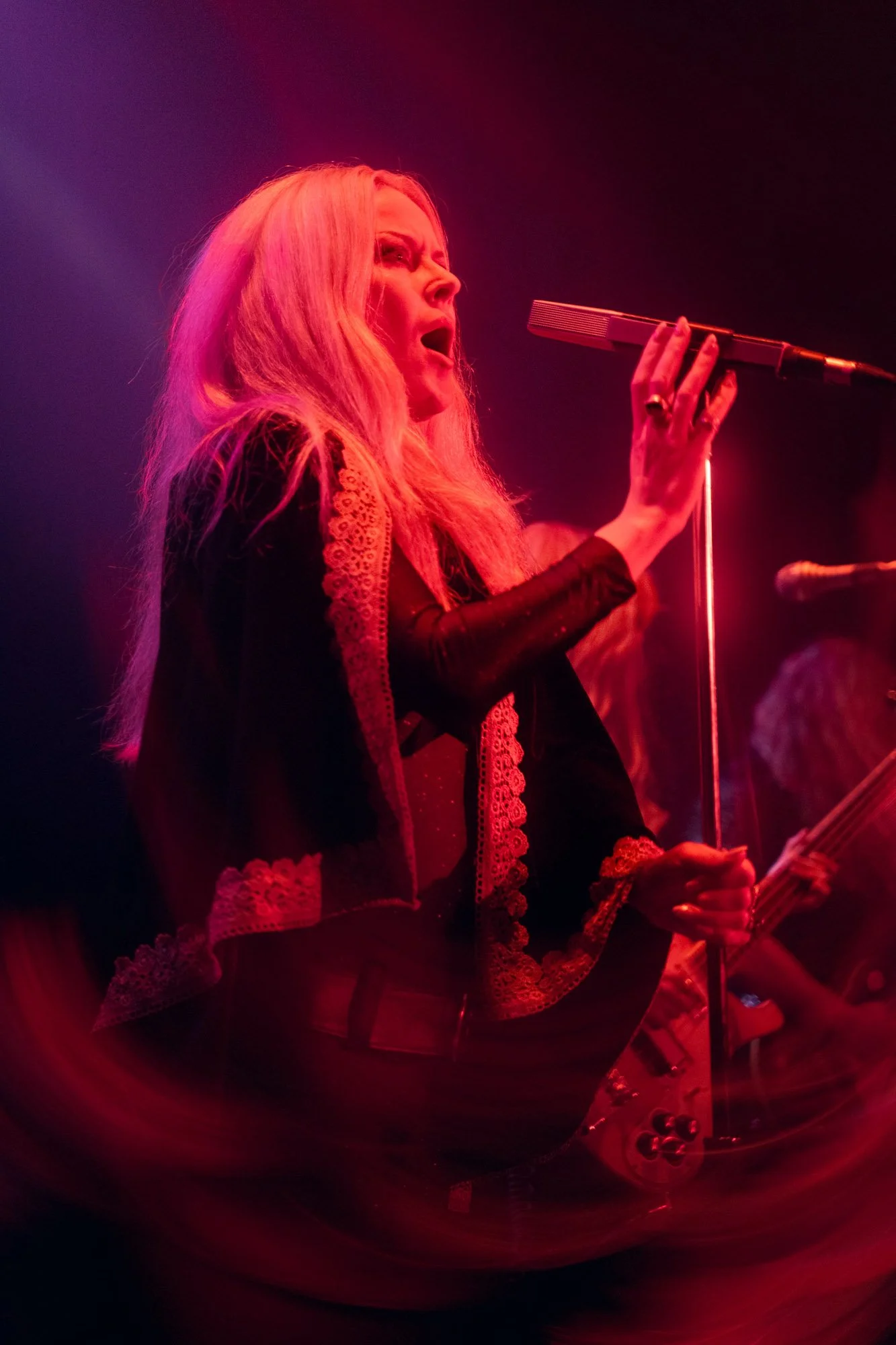 Johanna Sadonis singing into microphone during live Lucifer concert