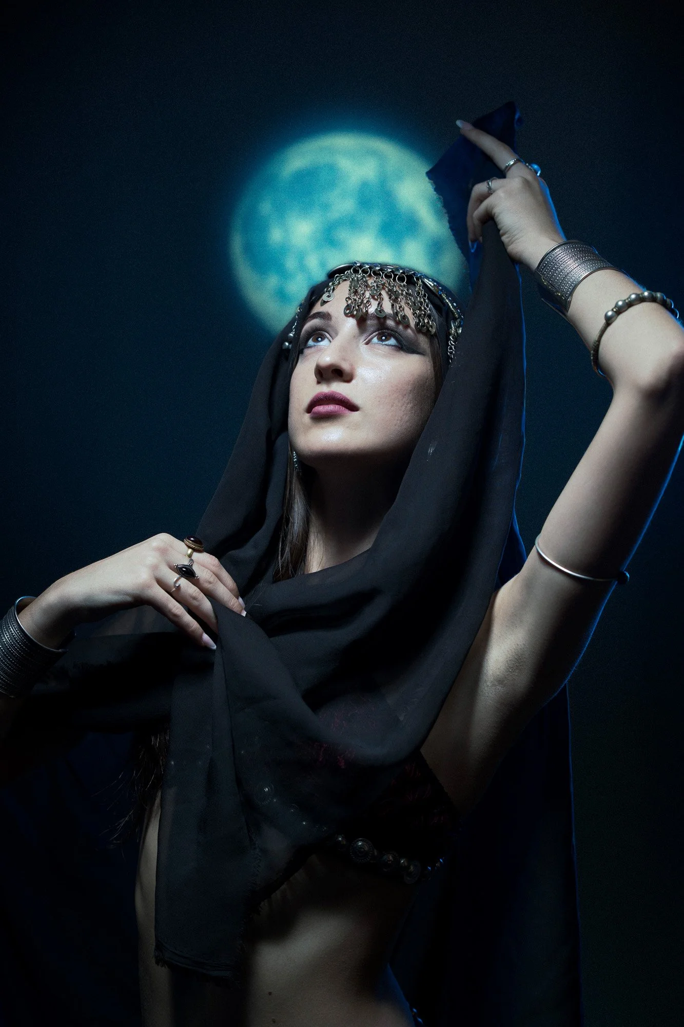Moonlit studio portrait exploring feminine energy and controlled movement.