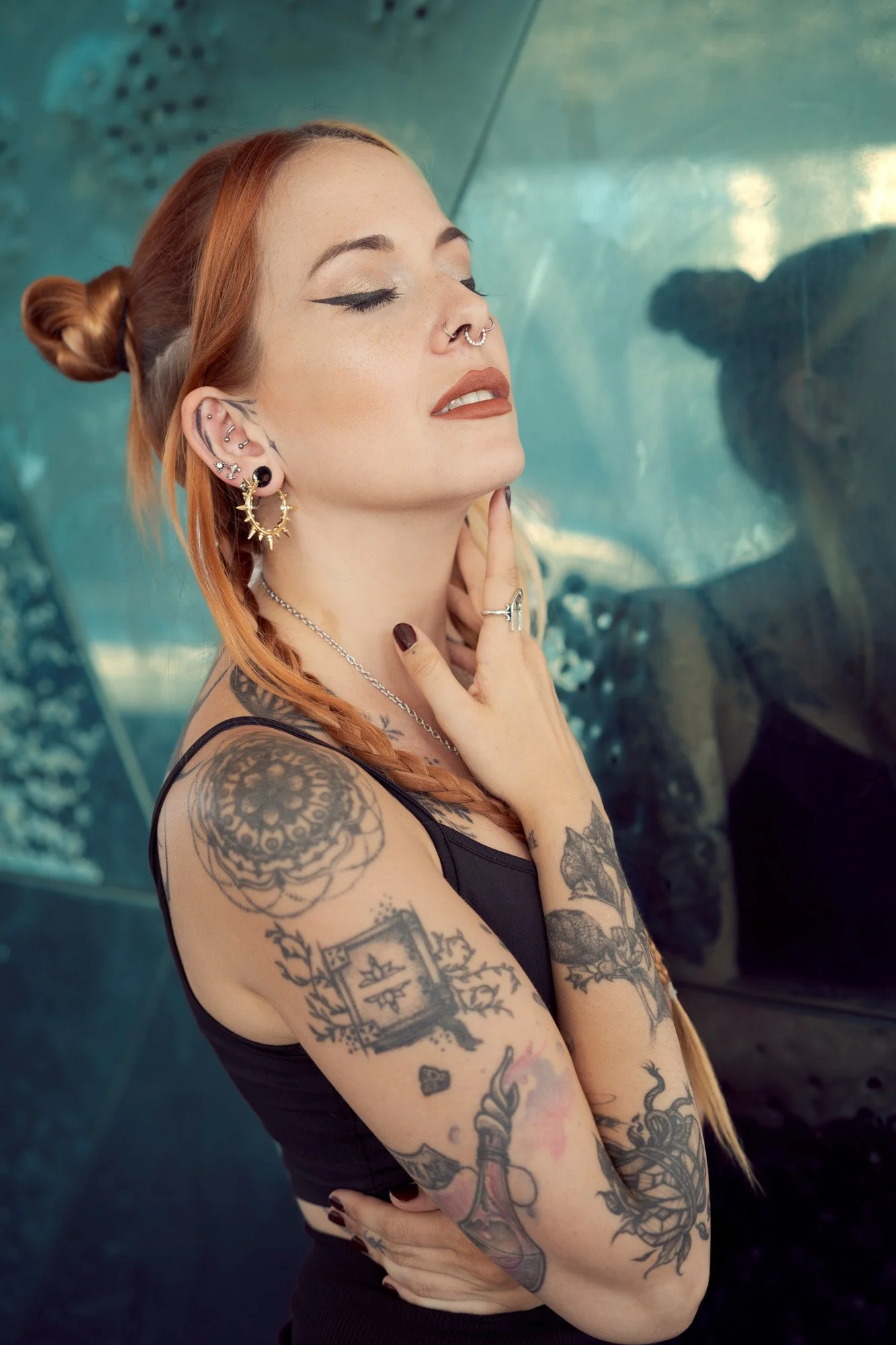 Close-up portrait of Shara Wolf wearing alternative jewelry and chain