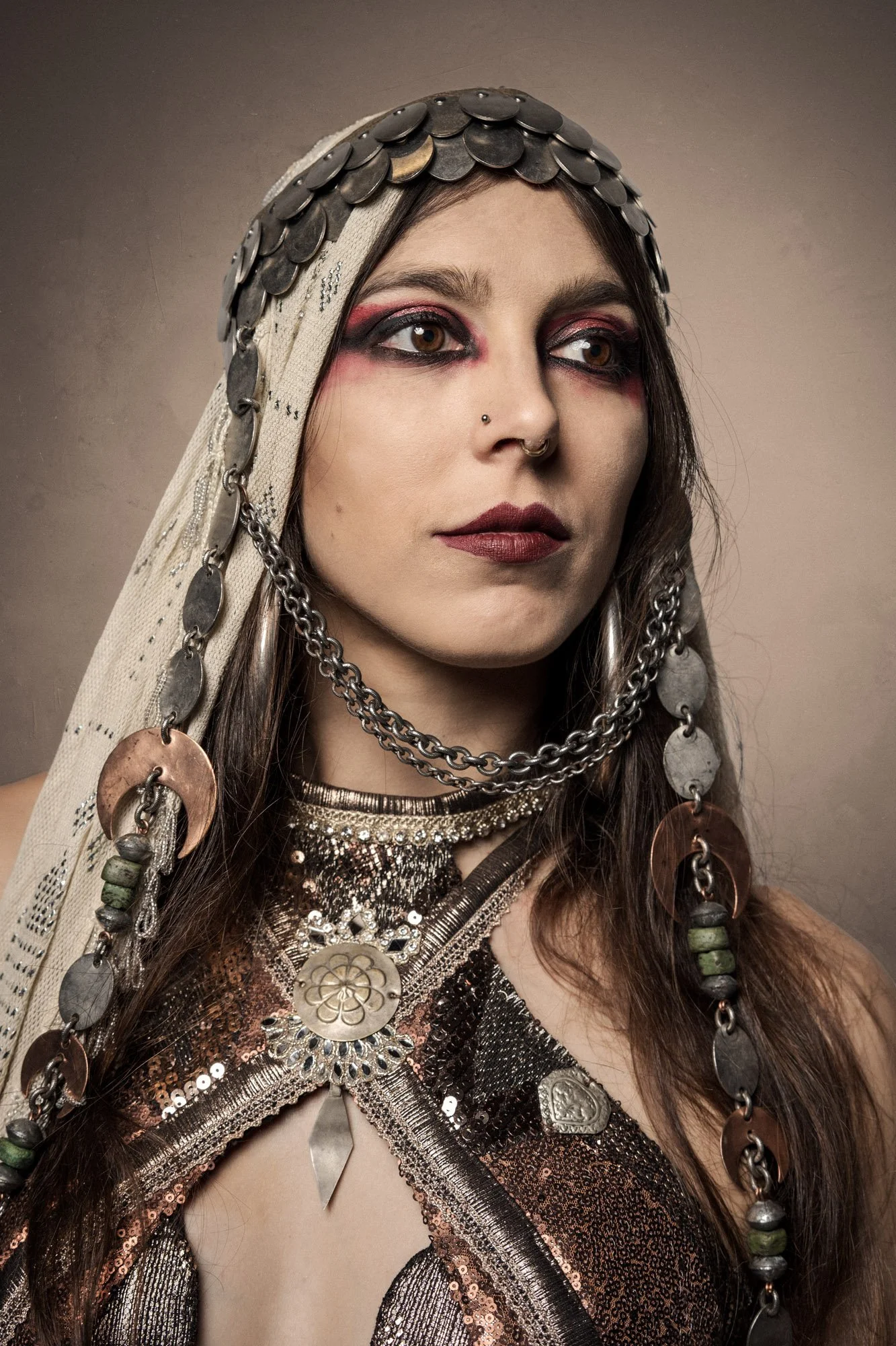 close portrait of Cosmosdaughter with detailed jewelry and ritual inspired styling