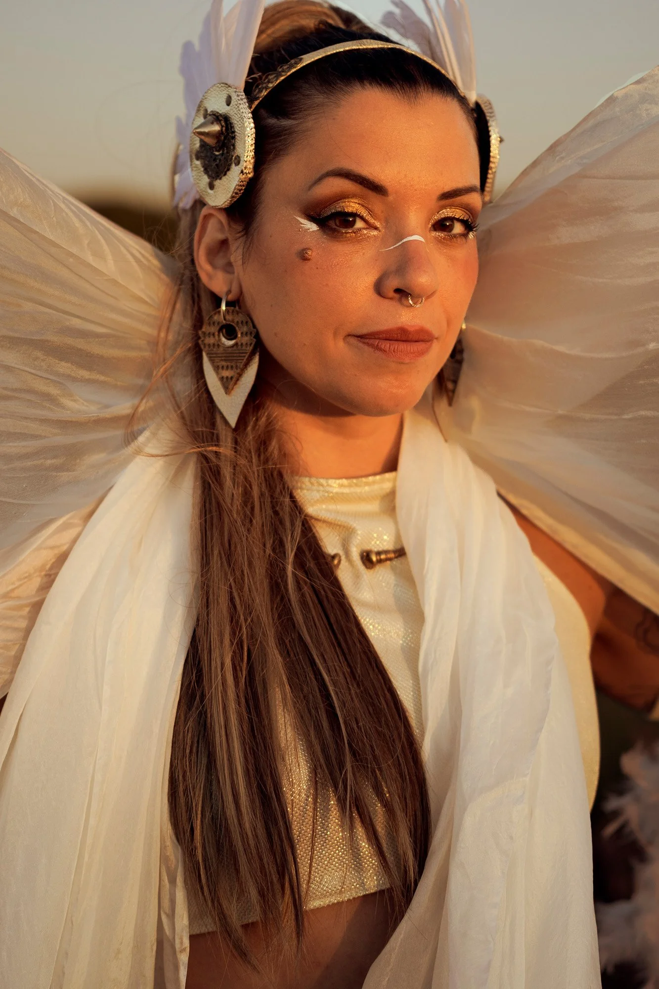 Soft portrait of Carla Imix in fantasy tribal styling with warm sunset tones.