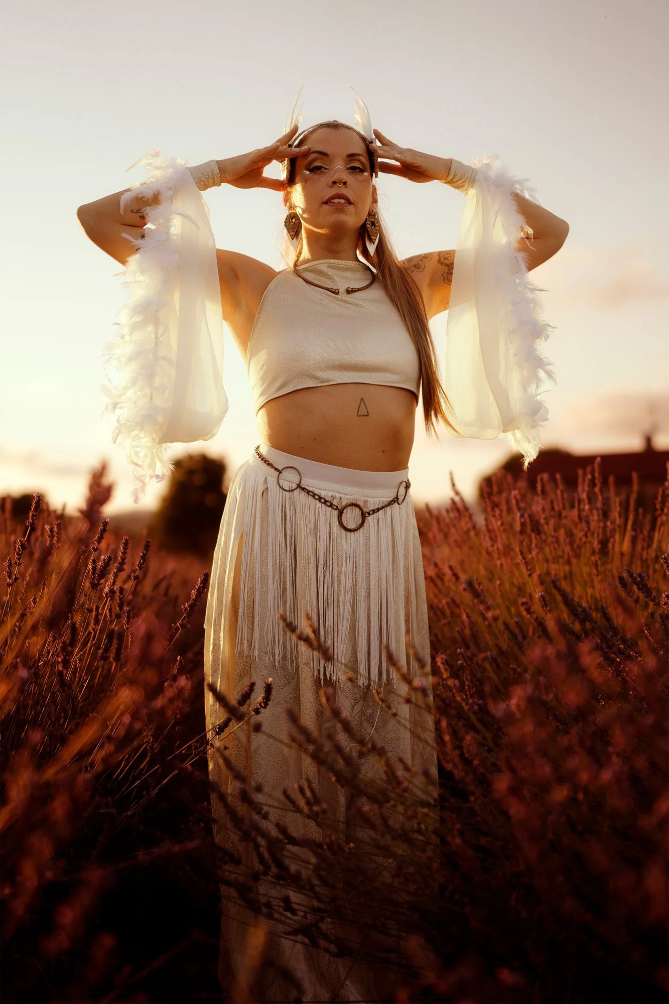 Tribal fusion dancer posing at sunset, ethereal styling and soft natural light.