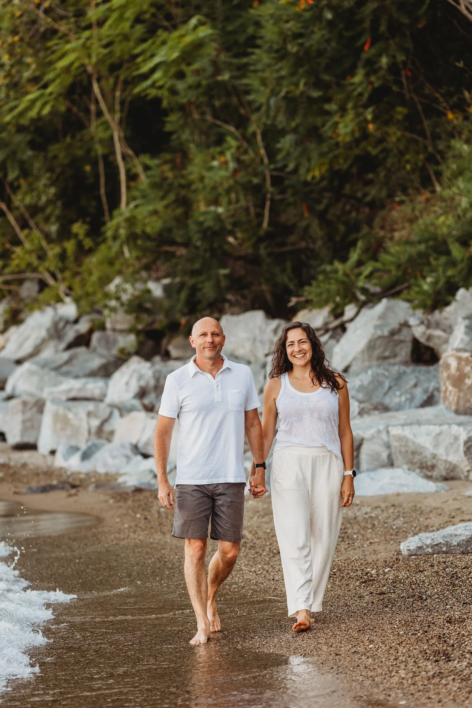 man woman holding hands walking down beach chicago il