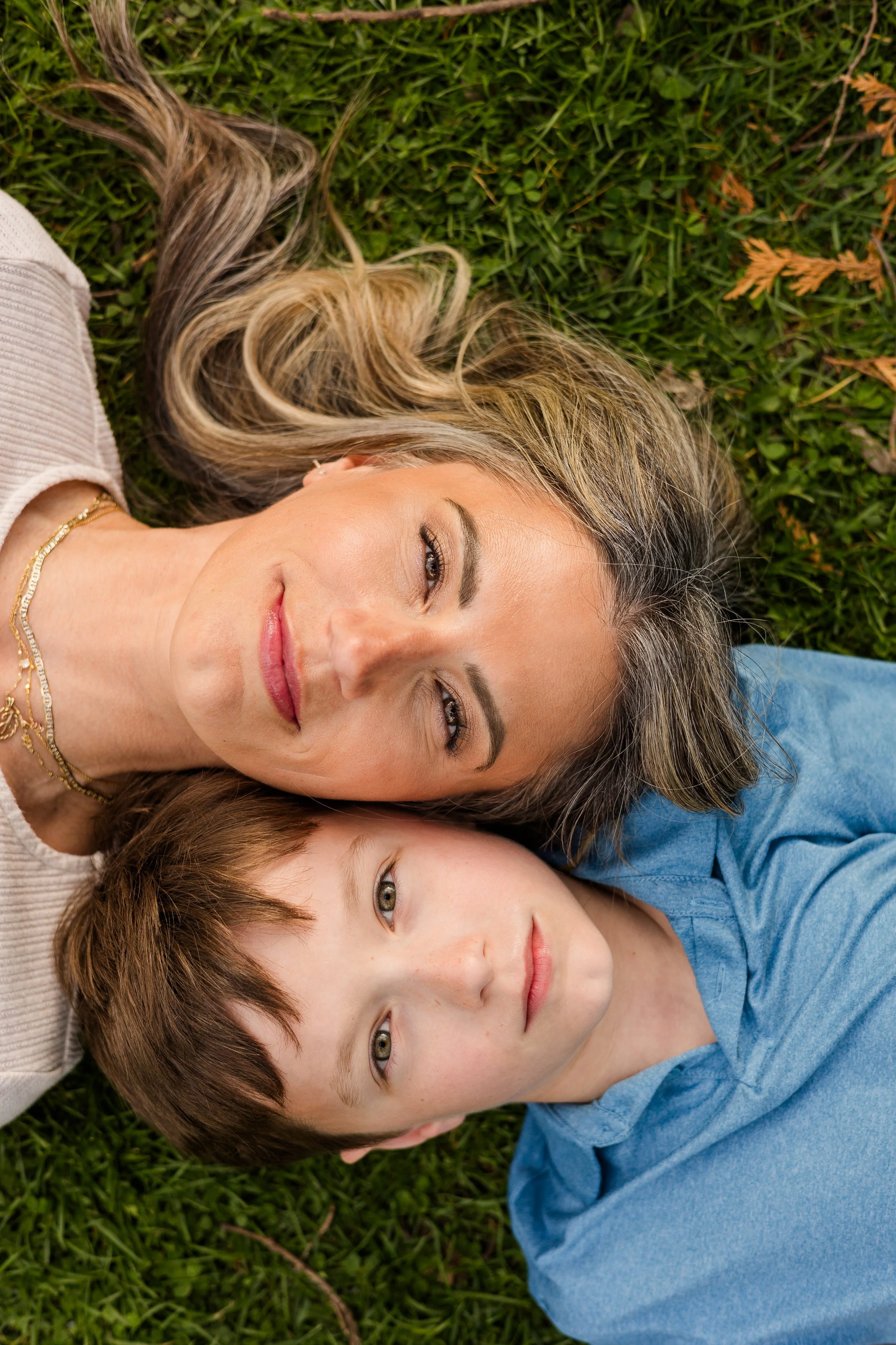 mother and son laying down looking at camera