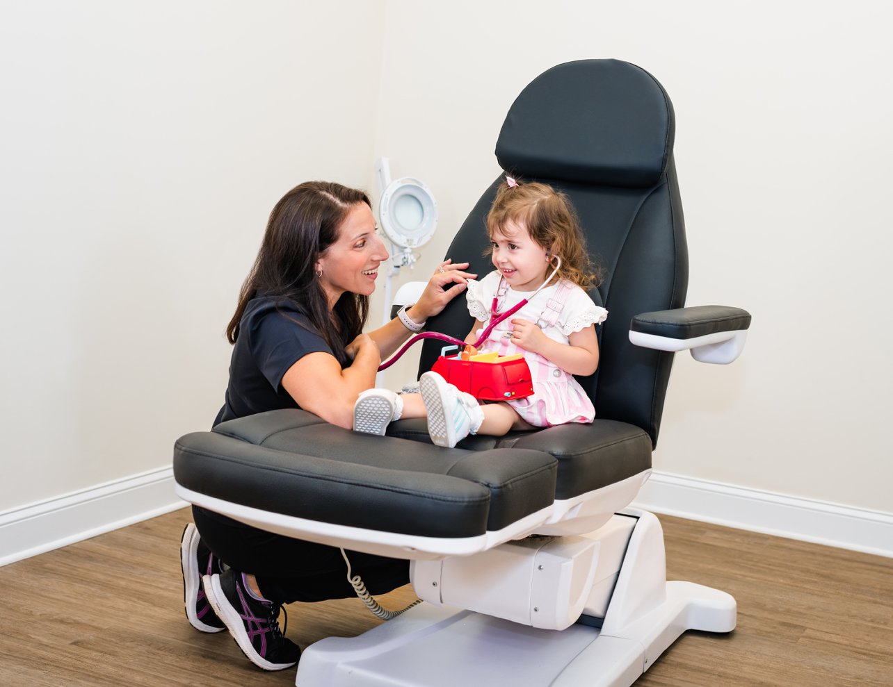 Marisa Olsen, DNP, FNP-C, caring for a young patient during a pediatric visit at R & R Collective Health.