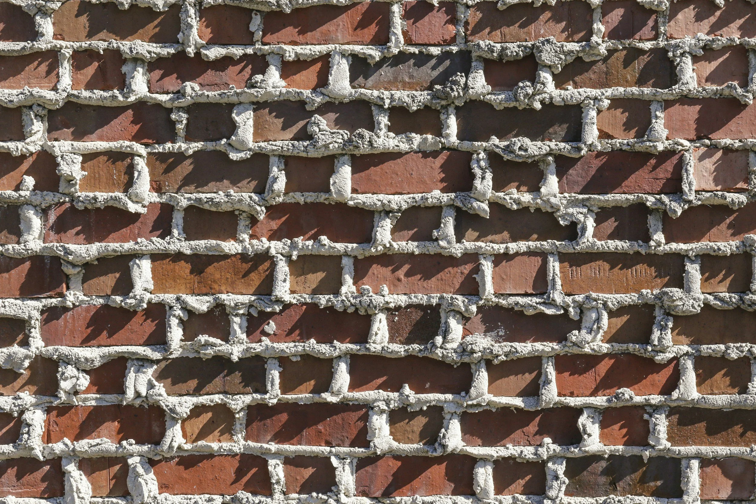 Close-up view of a brick wall with mortar between the bricks.