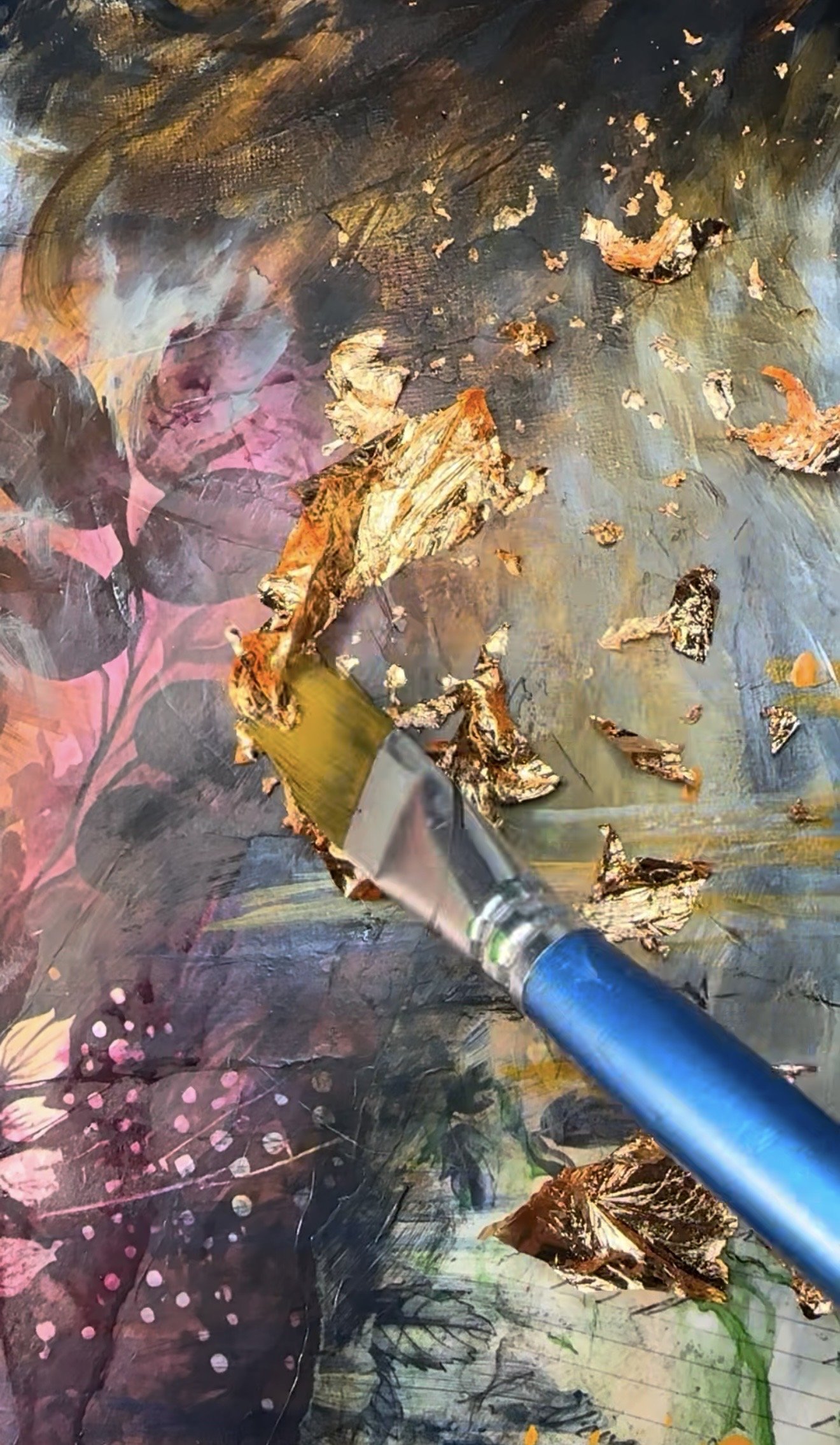Artist applying gold leaf to a textured JaeBird Studio mixed-media painting