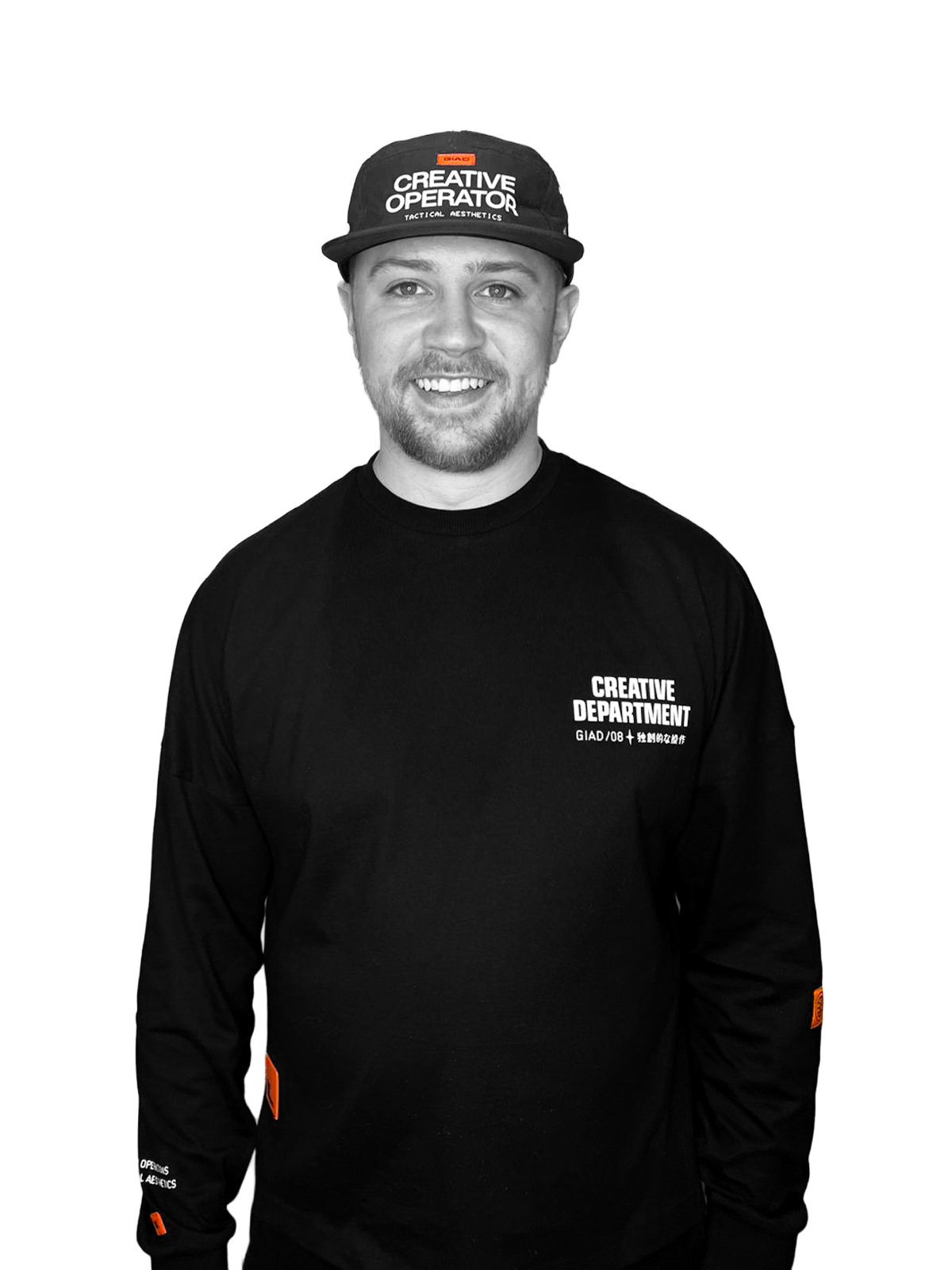 Joe Lane, independent brand designer wearing a black long-sleeve shirt with white text and a black cap with white text. The shirt has the words 'CREATIVE DEPARTMENT' and the cap has the words 'CREATIVE OPERATOR'.