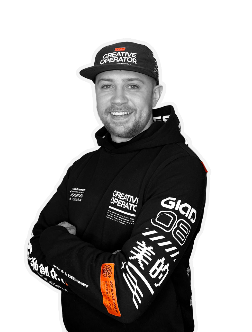Joe Lane wearing a black hoodie and a black cap with the logo and text 'Creative Operator'. The image has a high contrast, black-and-white style with some orange details on the cap and sleeve, and a plain background.