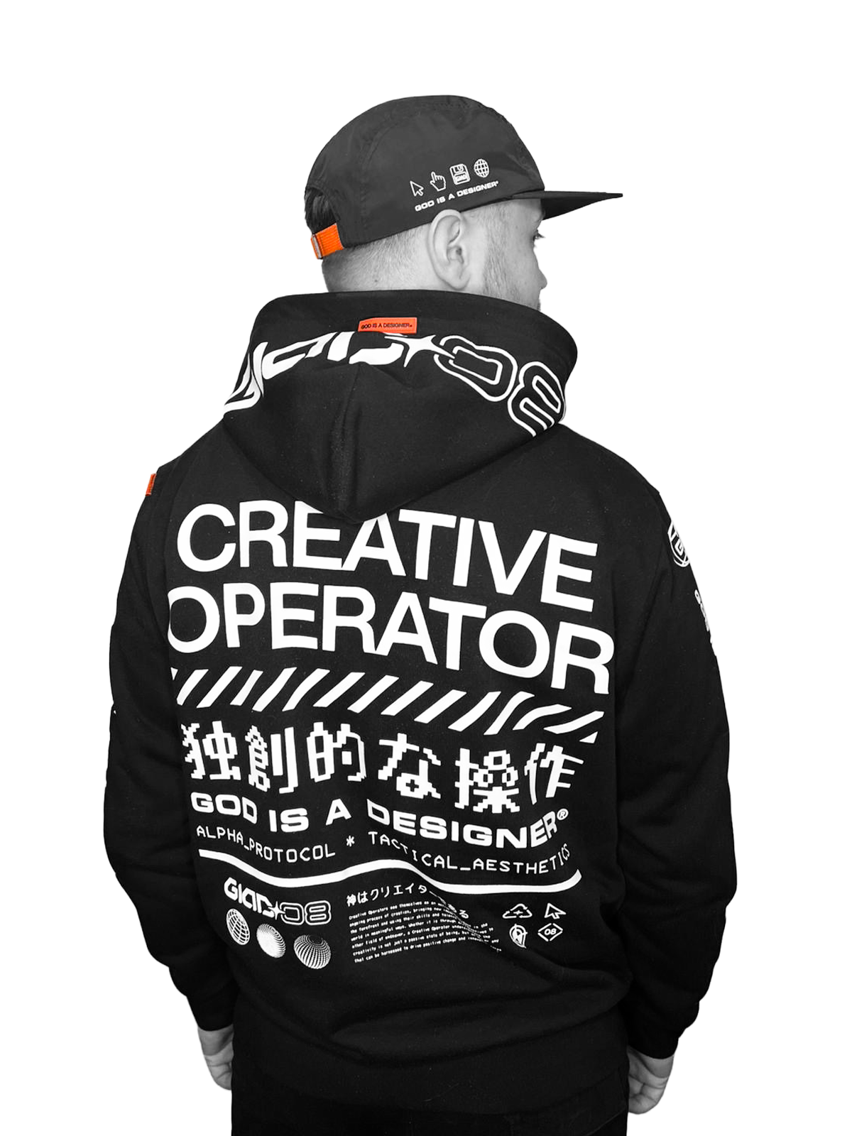 Joe Lane, independent brand designer wearing a black hoodie with white text that reads "Creative Operator," along with Japanese characters and other text, and a black baseball cap with icons and the phrase "God is a designer" on the back.