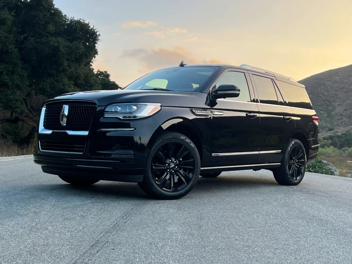 Black Lincoln Navigator SUV providing professional black car transportation in the Denver Metro area sunset.