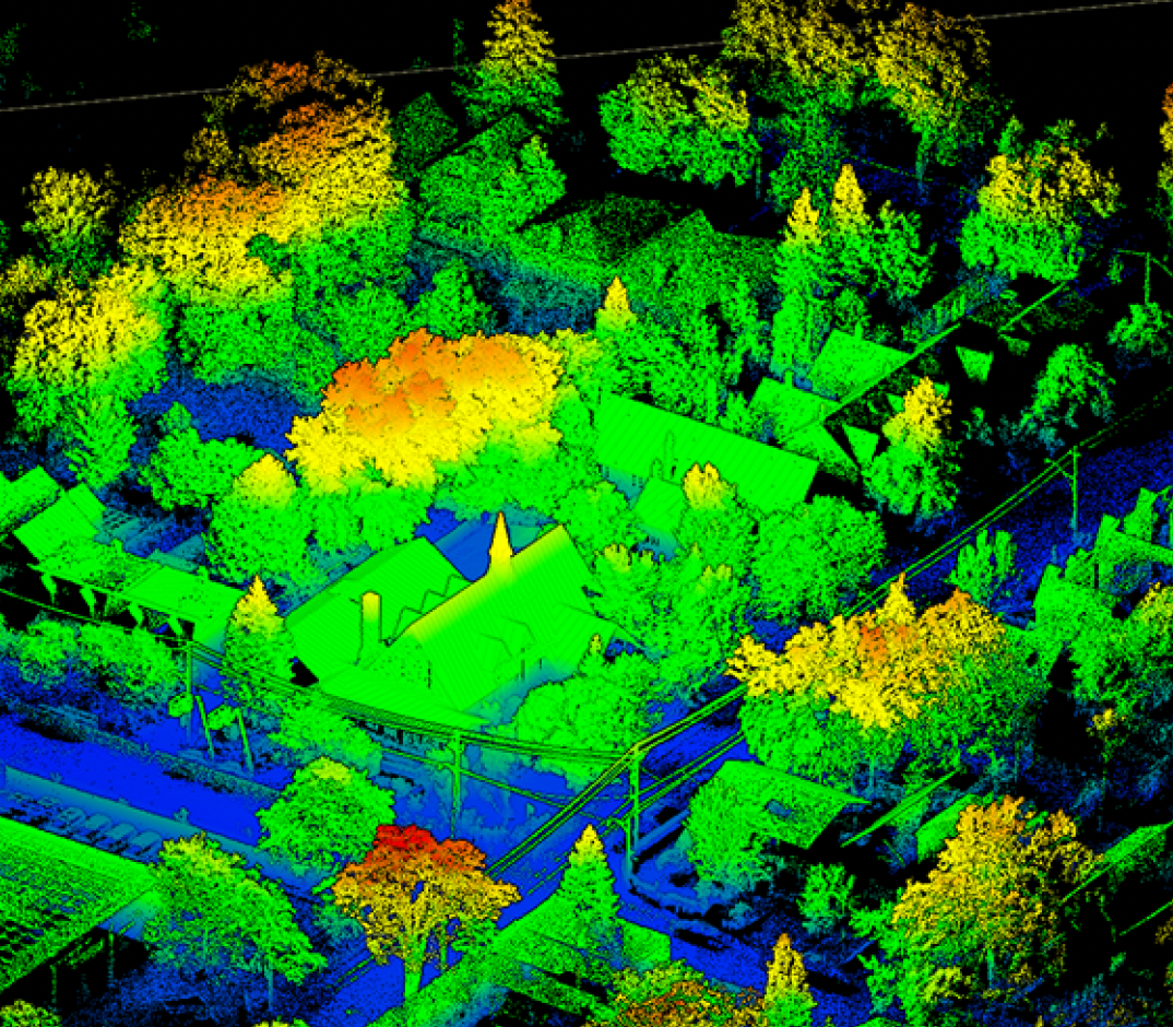 A colorful LiDAR point cloud image of a residential neighborhood with trees, houses, and power lines.