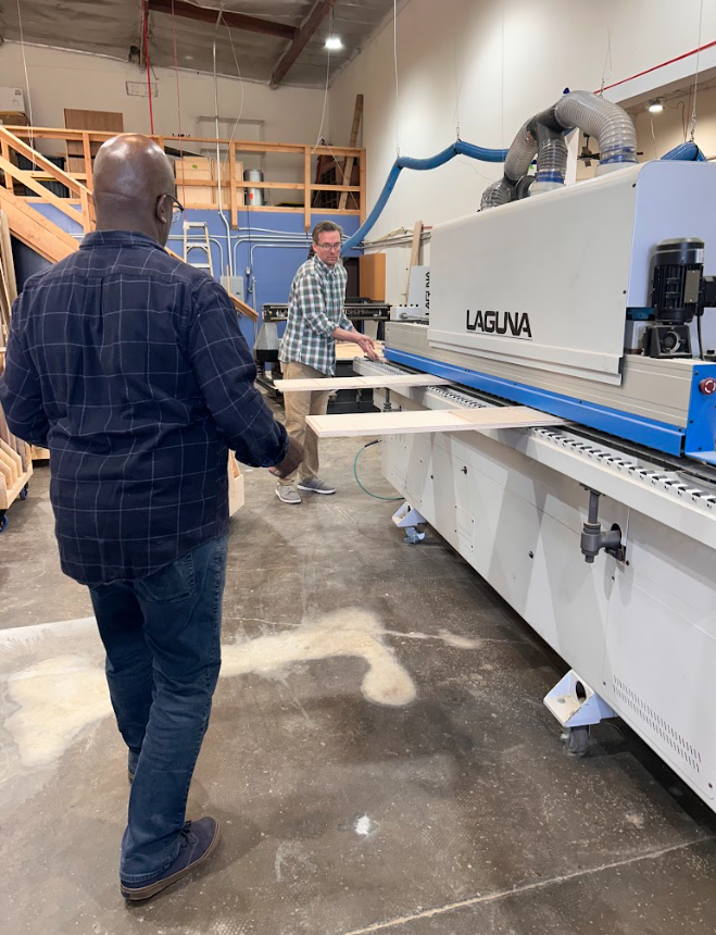 Corey and James with OC Custom Wood Design using the CNC machine to create custom wood furniture, cabinets and shelving.