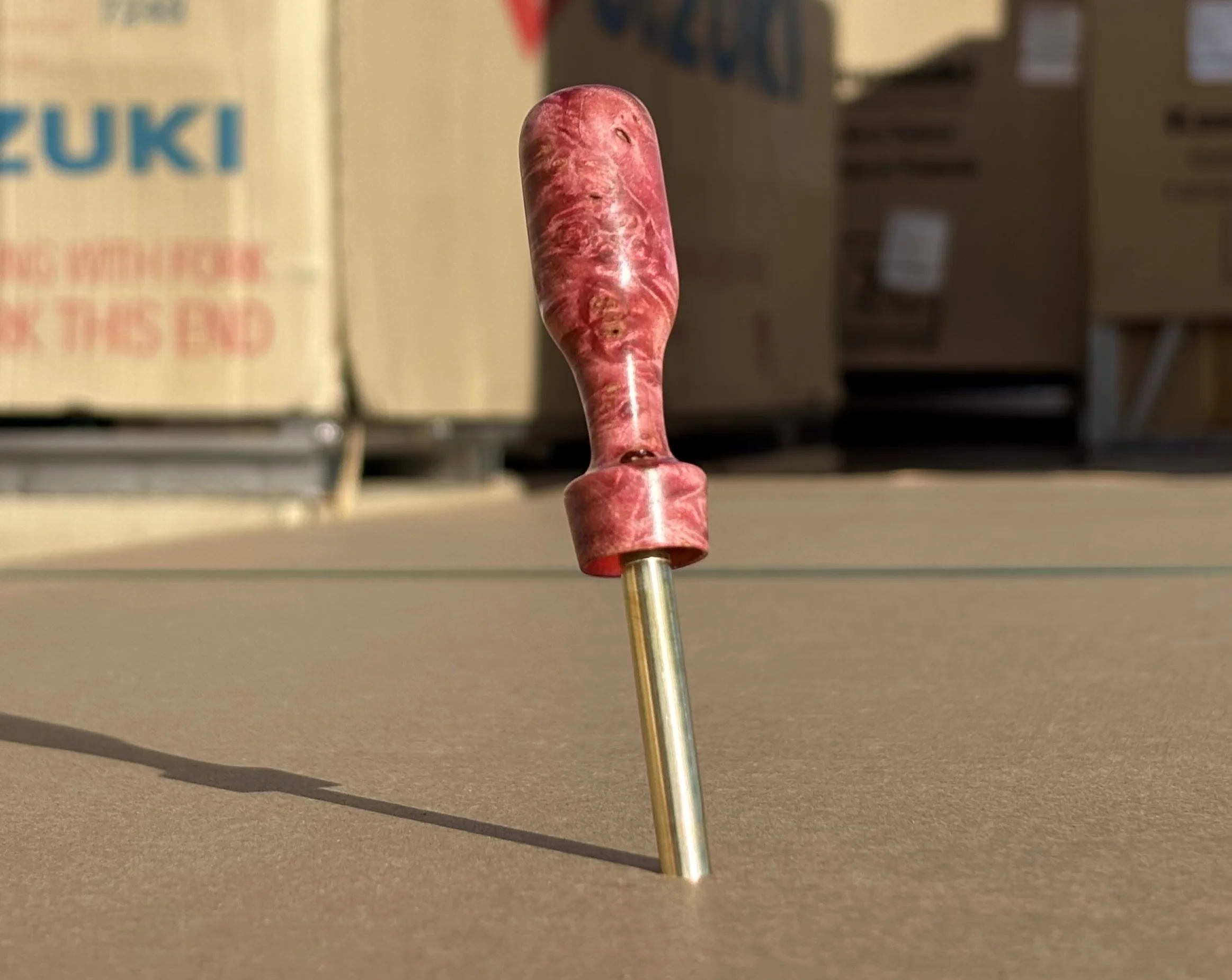 Divot tool for golf made from dyed stabilized maple burl. Single prong made from Brass. Tool is in the shape of a bomb