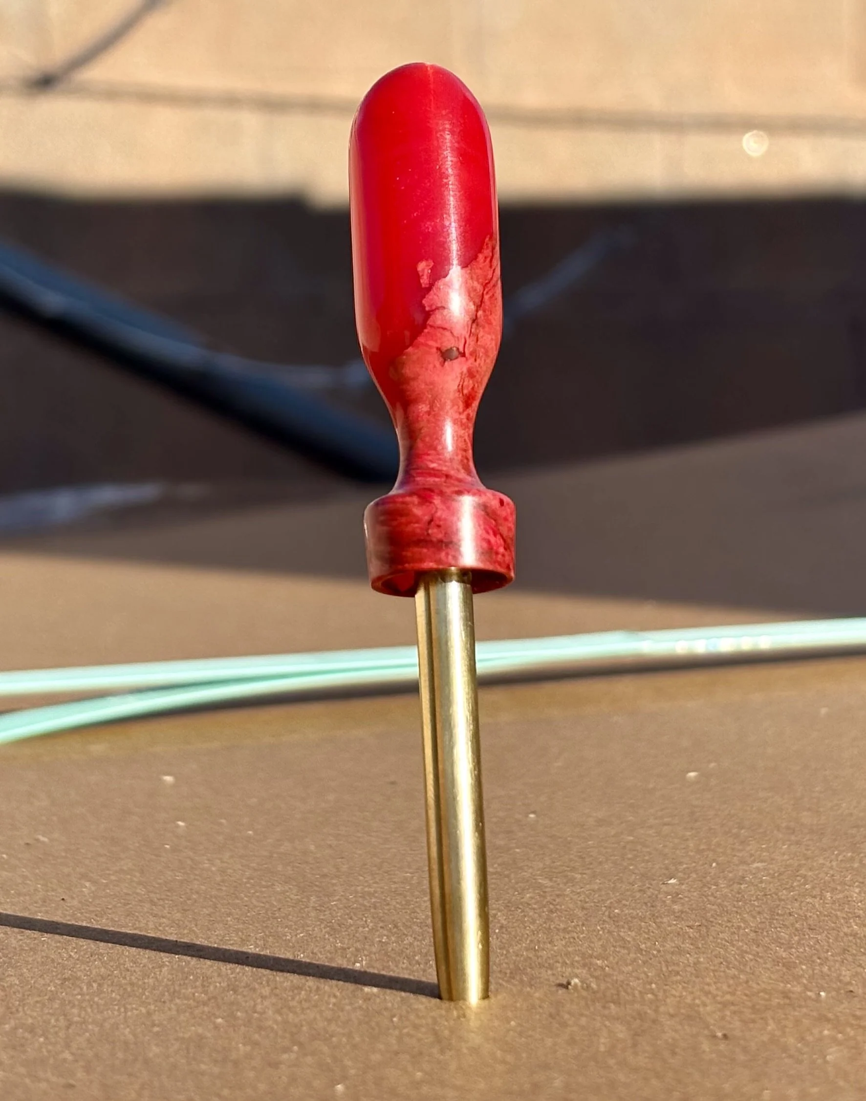 Divot tool for golf made from dyed stabilized maple burl. Single prong made from Brass. Tool is in the shape of a bomb