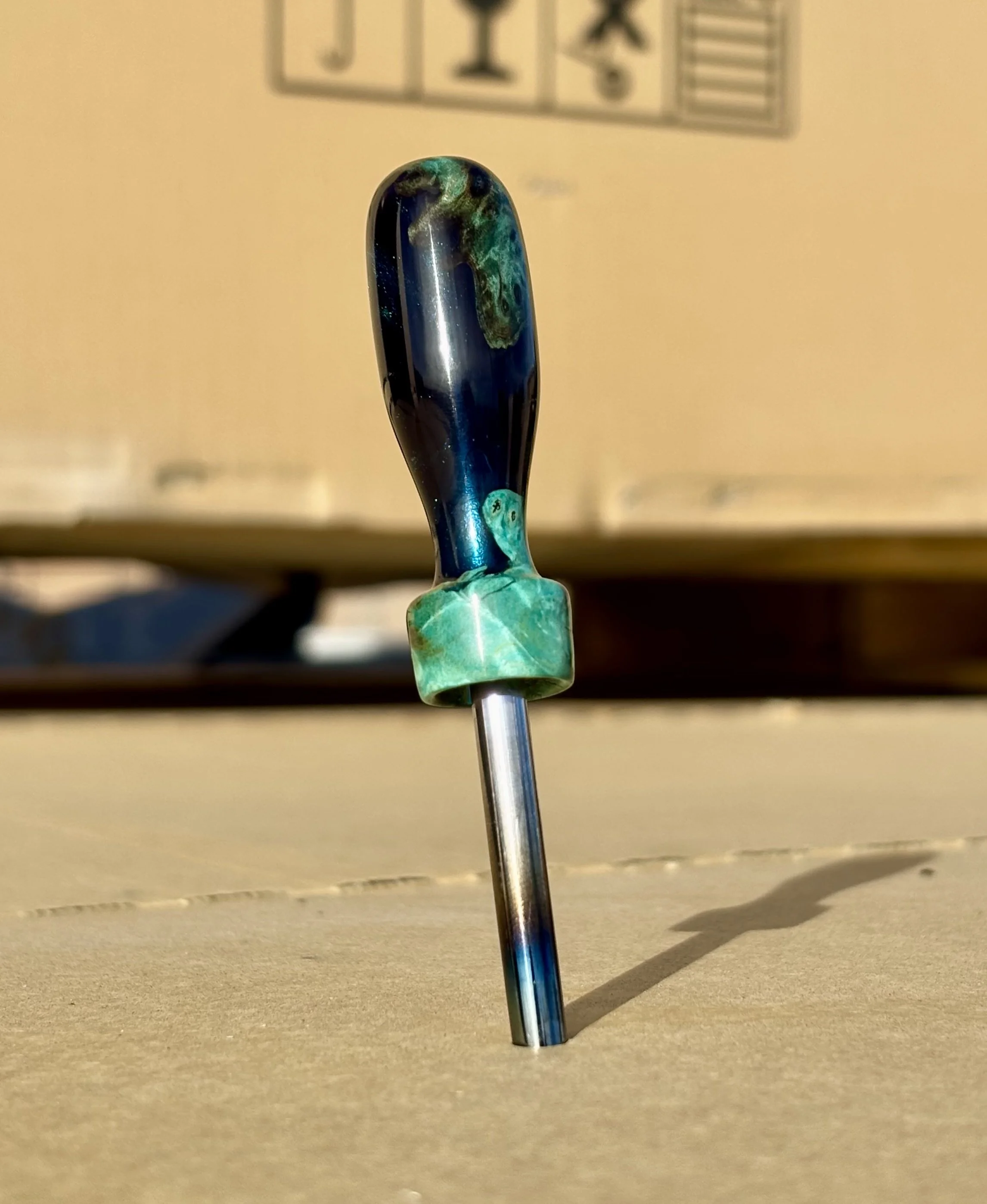 Divot tool for golf made from dyed stabilized maple burl. Single prong made from heat treated steel. Tool is in the shape of a bomb