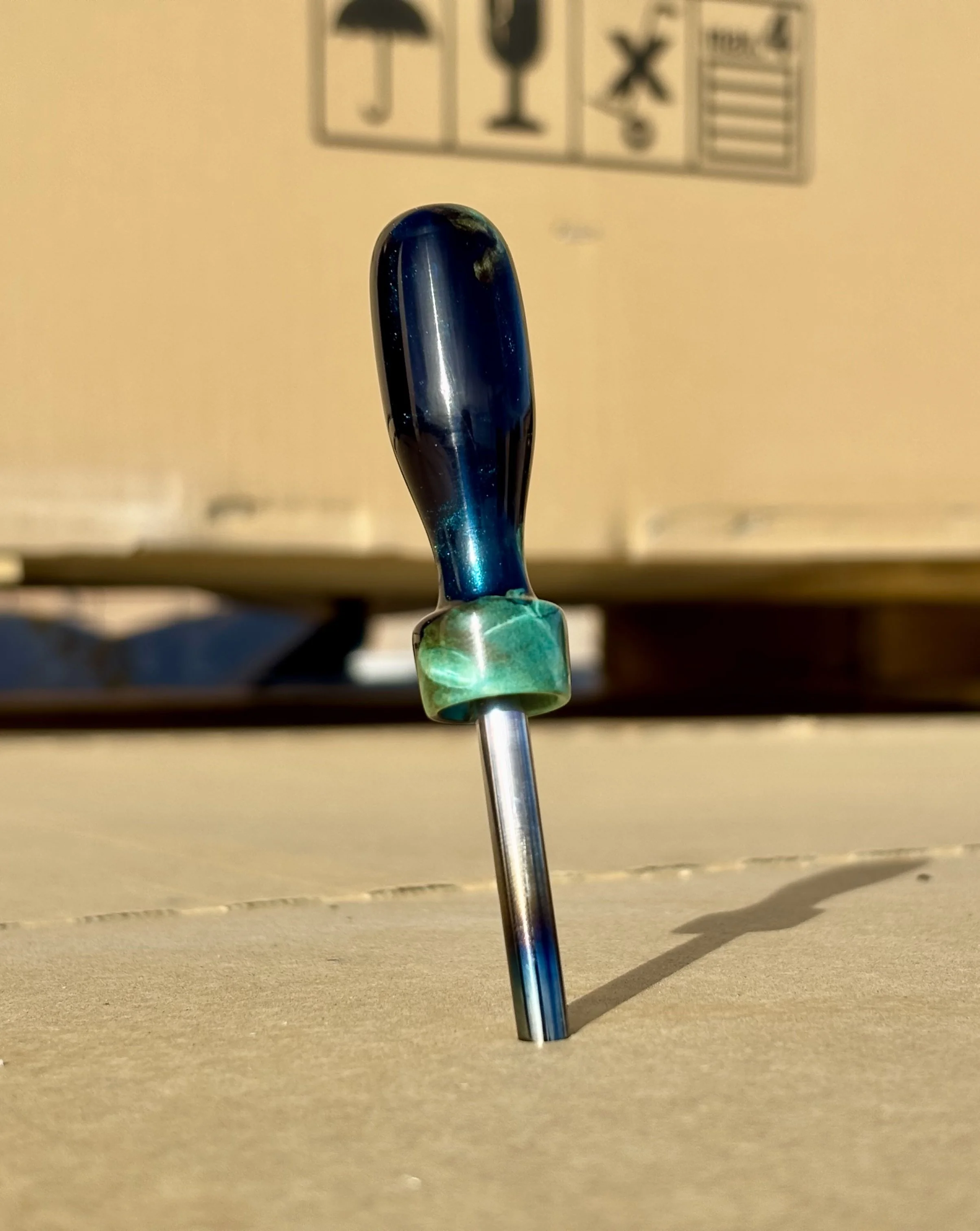 Divot tool for golf made from dyed stabilized maple burl. Single prong made from heat treated steel. Tool is in the shape of a bomb