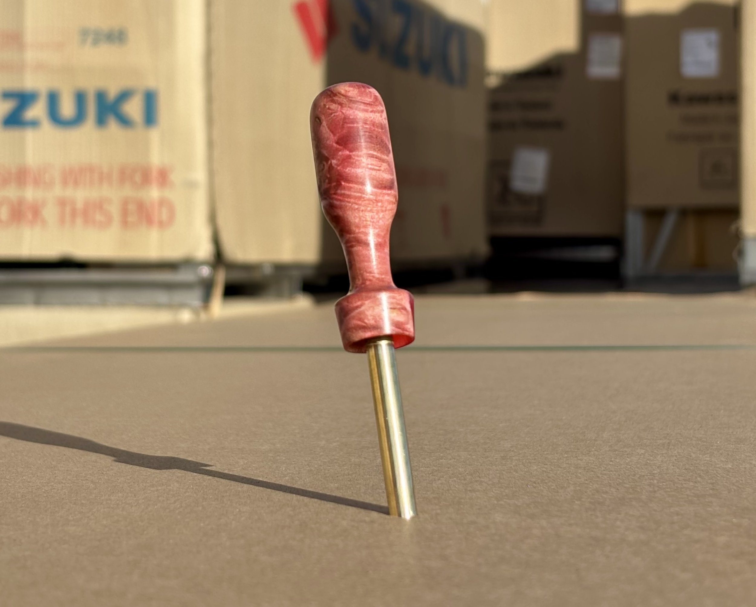 Divot tool for golf made from dyed stabilized maple burl. Single prong made from Brass. Tool is in the shape of a bomb