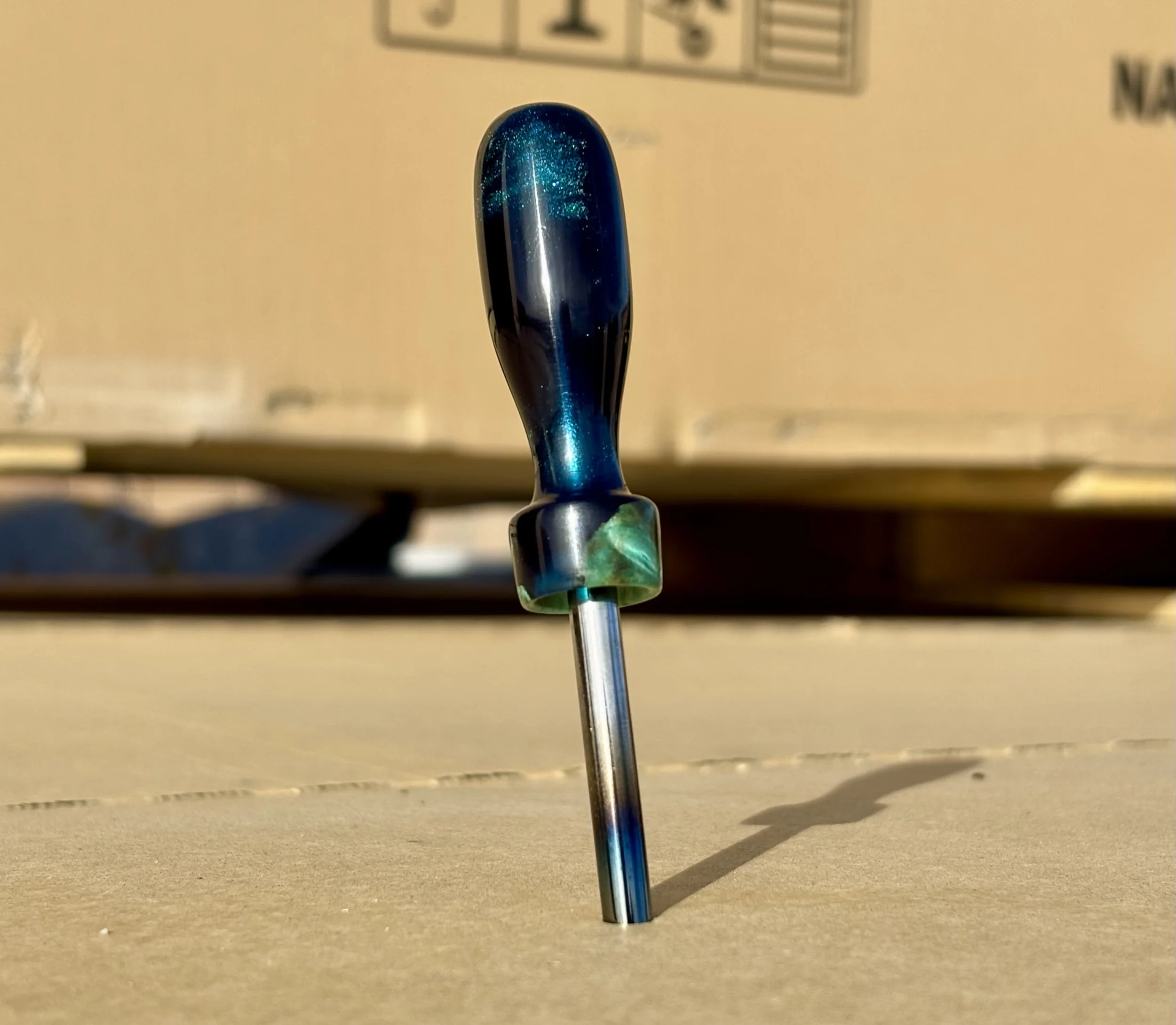 Divot tool for golf made from dyed stabilized maple burl. Single prong made from heat treated steel. Tool is in the shape of a bomb