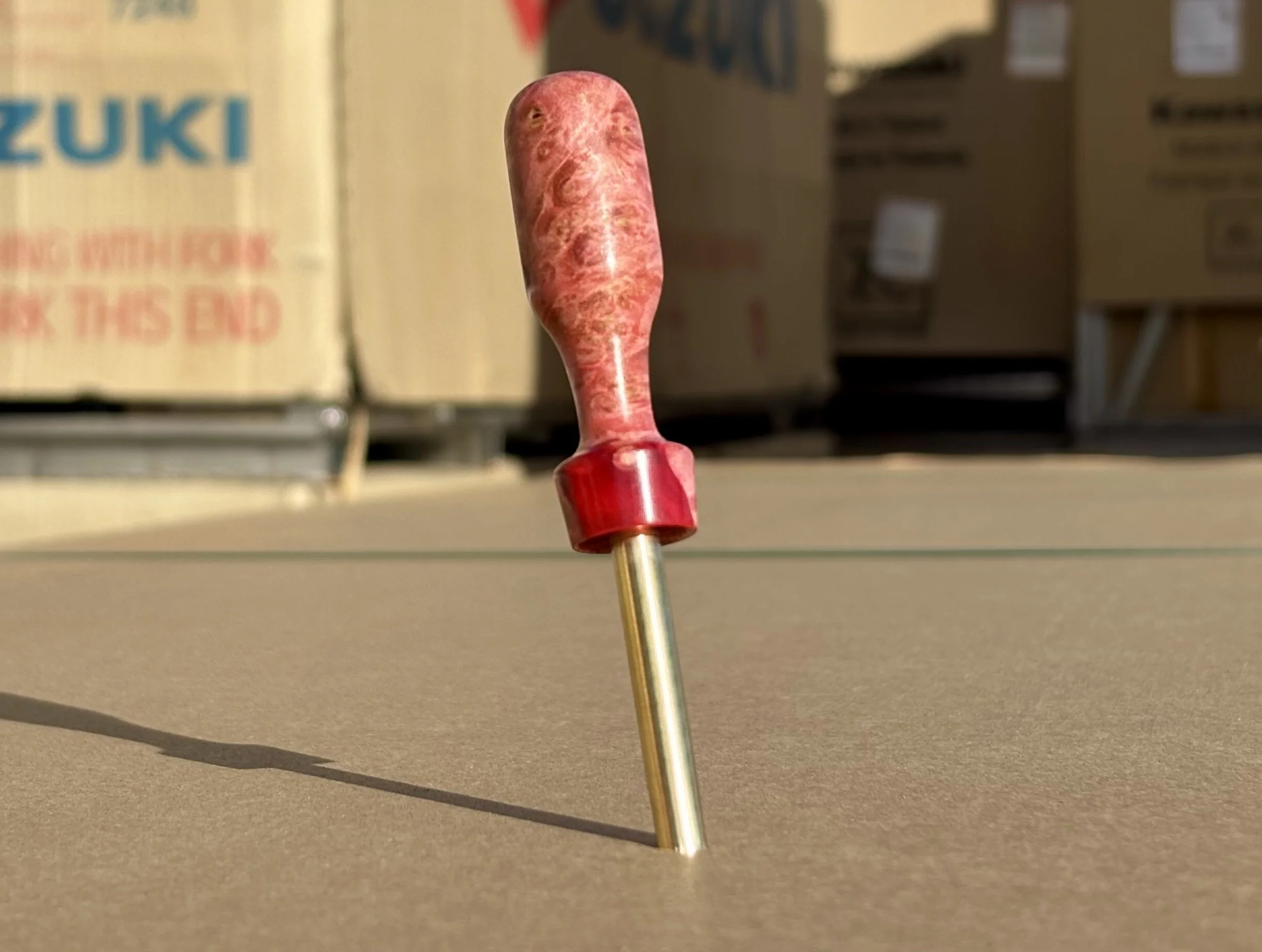 Divot tool for golf made from dyed stabilized maple burl. Single prong made from Brass. Tool is in the shape of a bomb