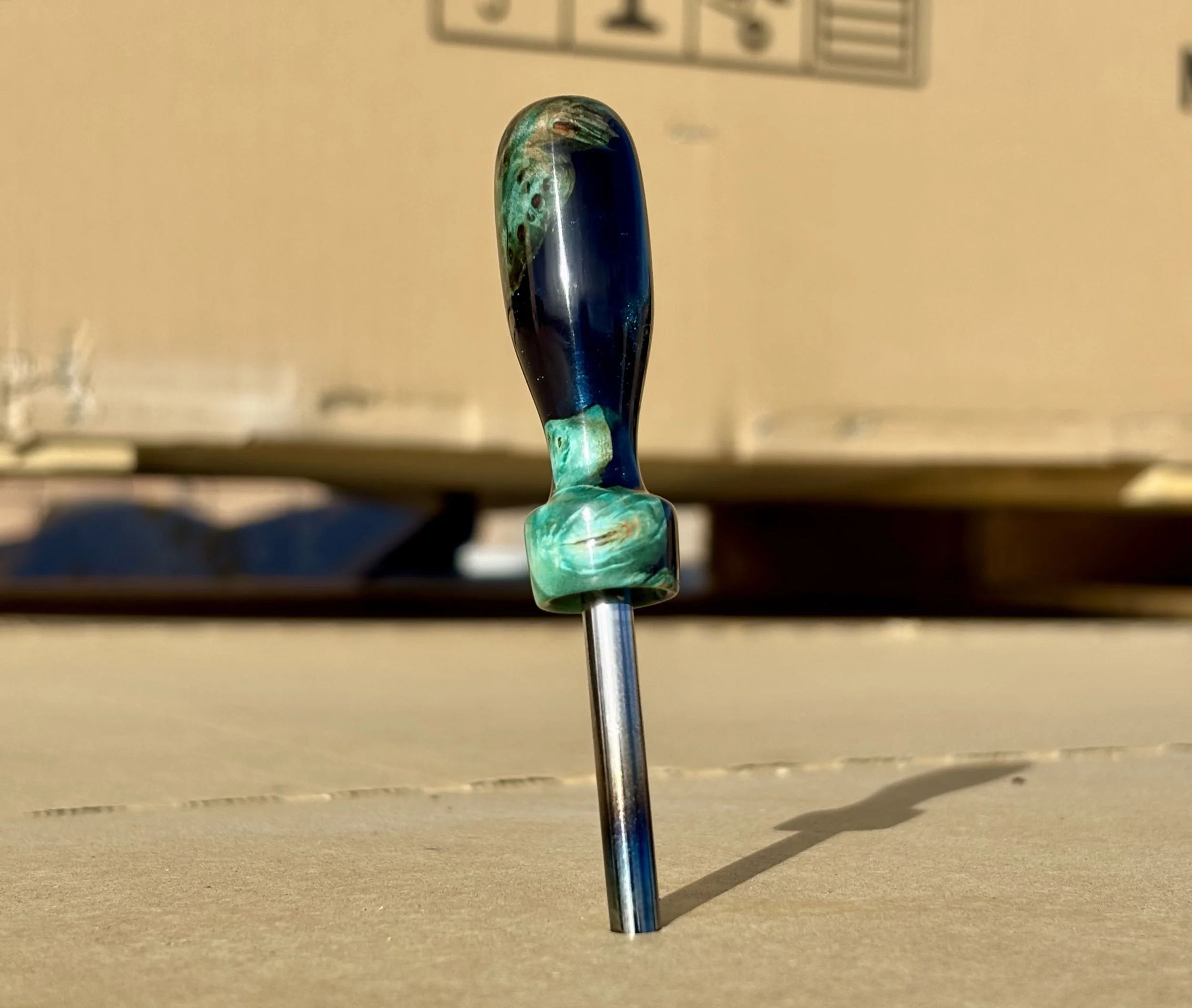 Divot tool for golf made from dyed stabilized maple burl. Single prong made from heat treated steel. Tool is in the shape of a bomb