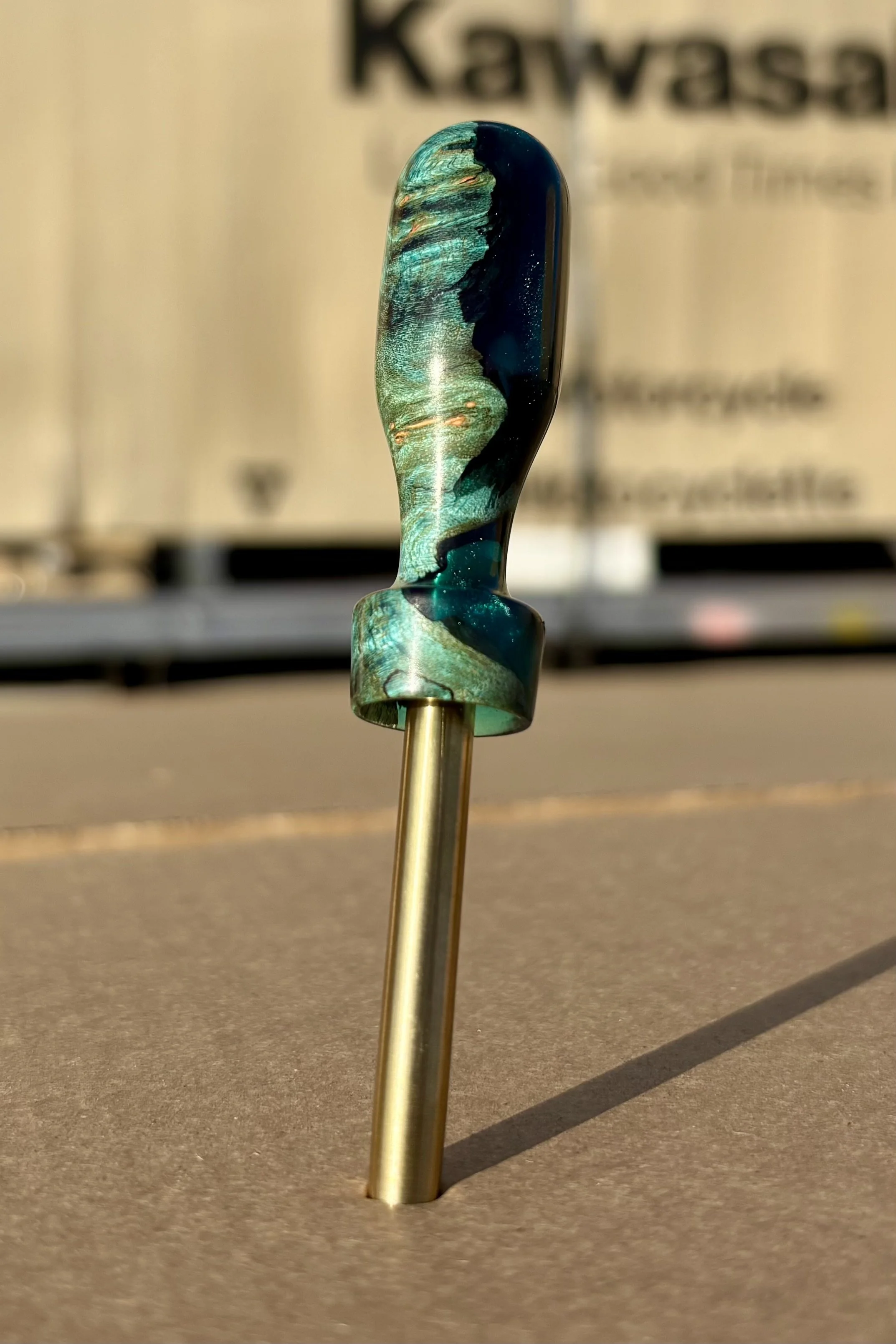 Divot tool for golf made from dyed stabilized maple burl. Single prong made from Brass. Tool is in the shape of a bomb