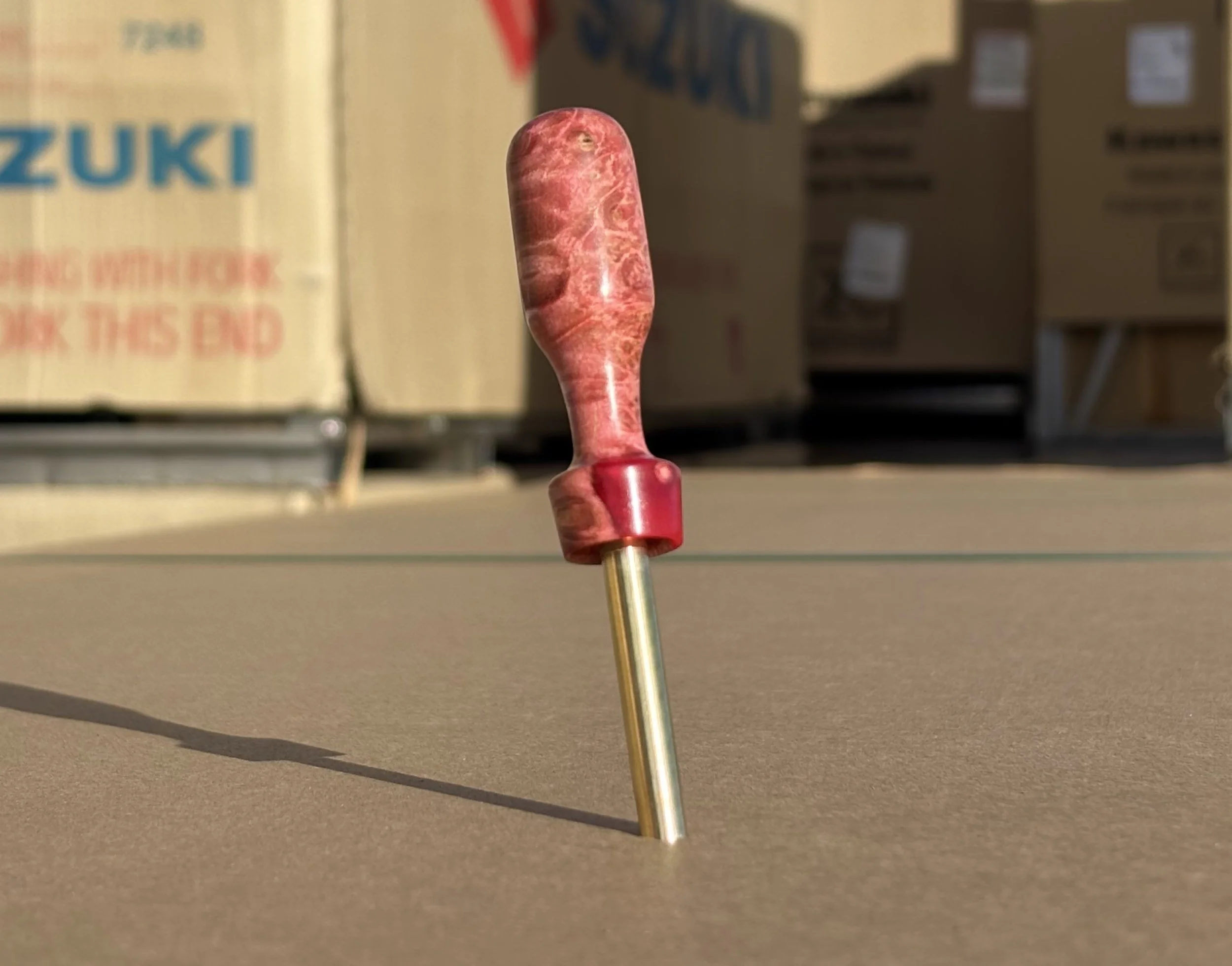 Divot tool for golf made from dyed stabilized maple burl. Single prong made from Brass. Tool is in the shape of a bomb