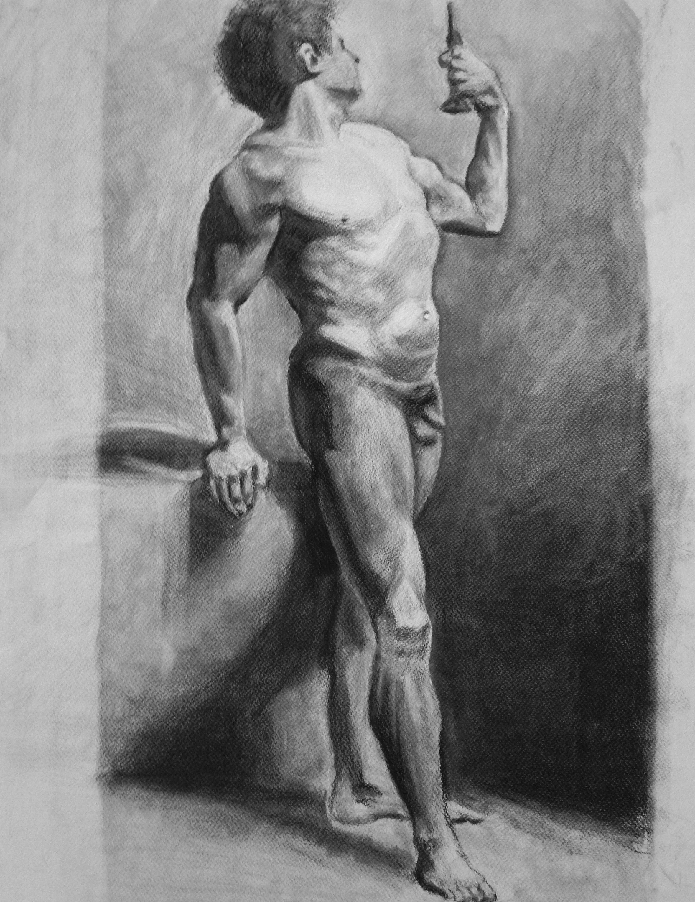 A detailed pencil sketch of a muscular man with curly hair, standing in a relaxed pose, holding a small object in his left hand while looking at it, with a shadowed background.