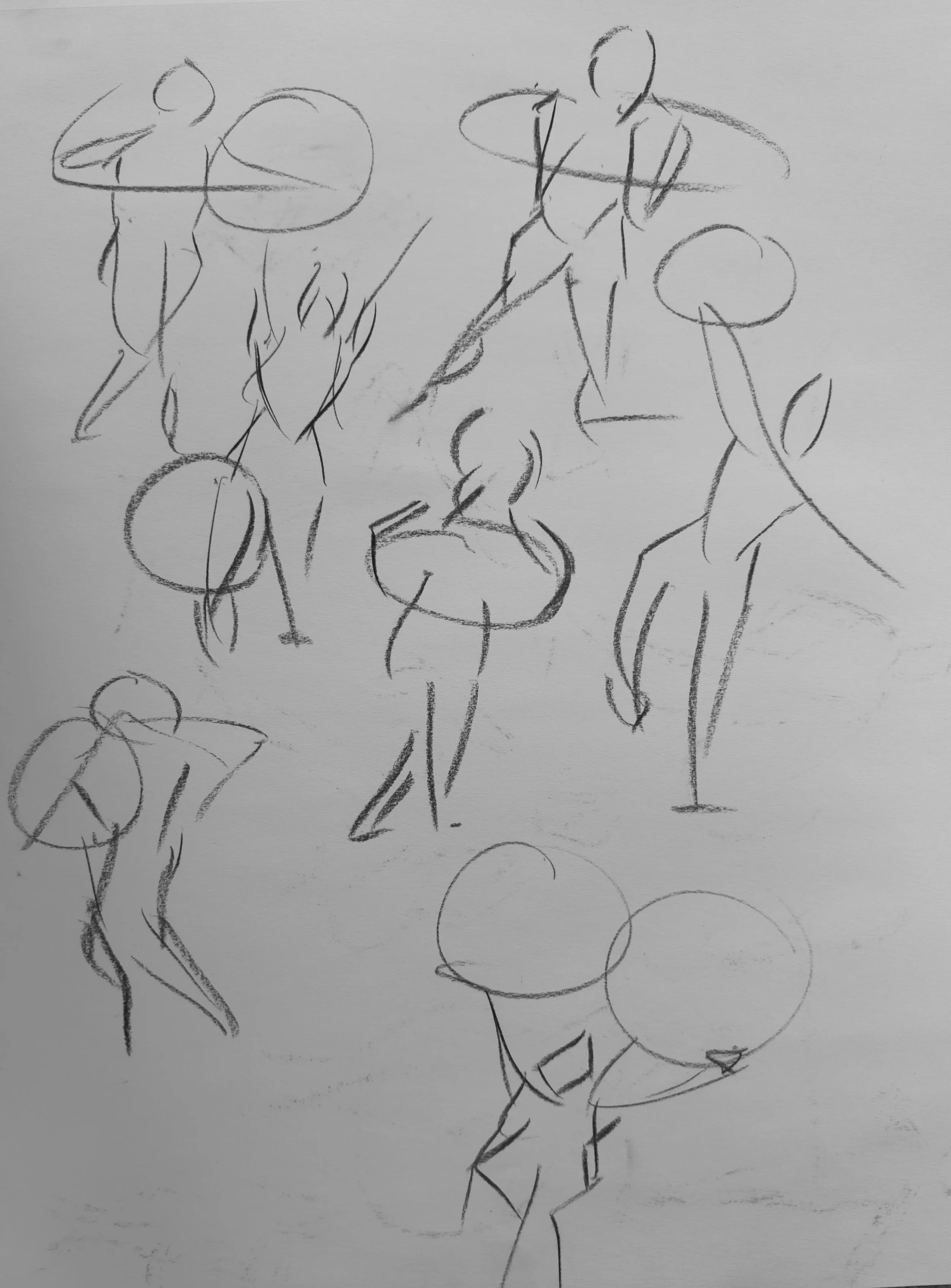 Sketch of multiple human figures in various poses, drawn with loose, quick lines, some holding or interacting with circular objects.